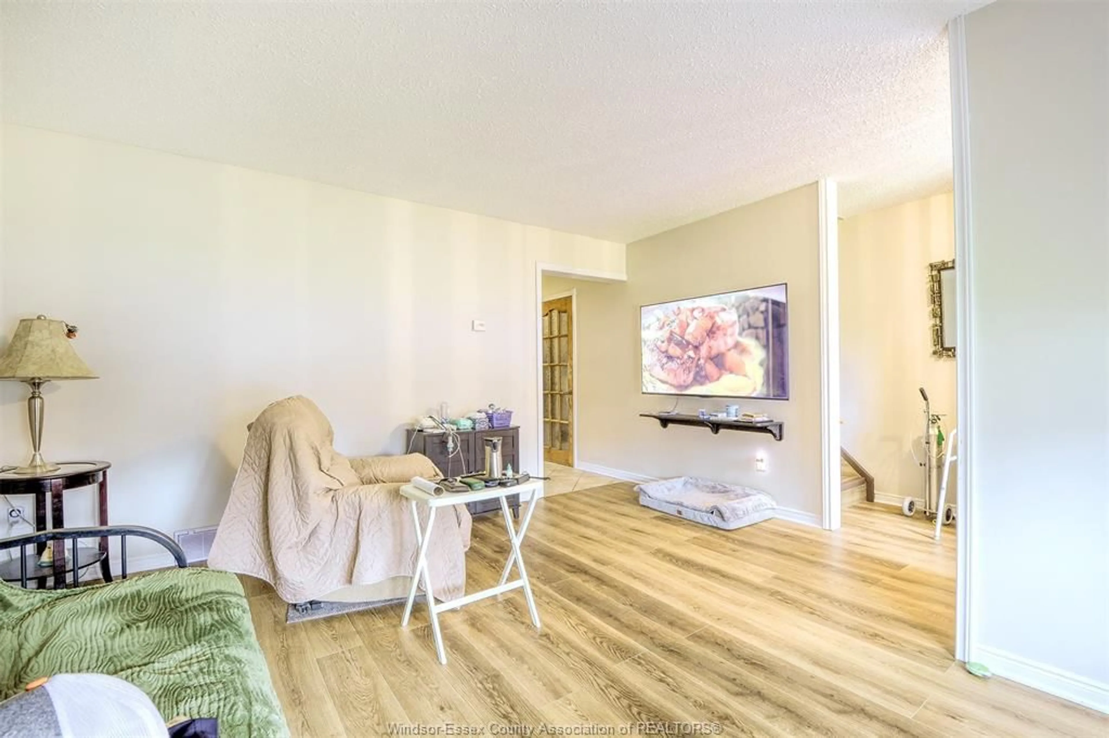 Living room with furniture, wood/laminate floor for 9445 ALTEN Dr, Windsor Ontario N8R 1V9