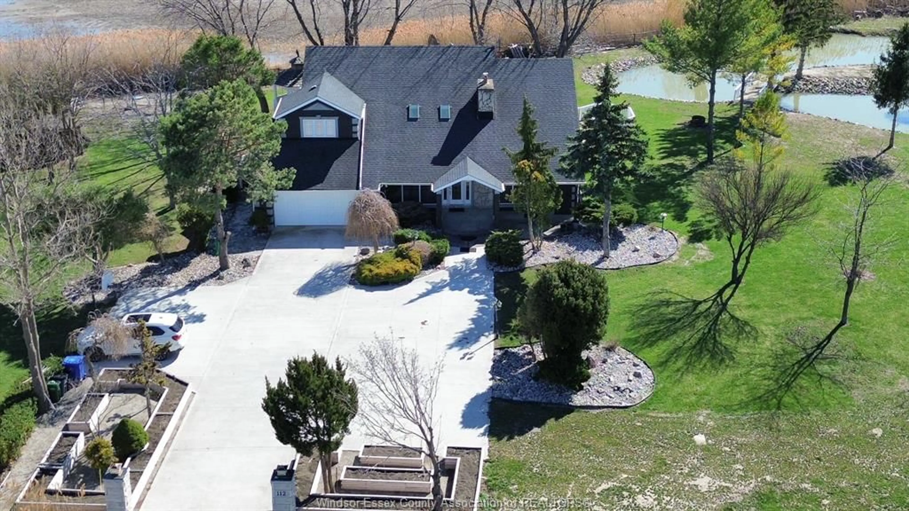 A pic from outside/outdoor area/front of a property/back of a property/a pic from drone, street for 112 COUNTY RD 22, Belle River Ontario N8L 1H8