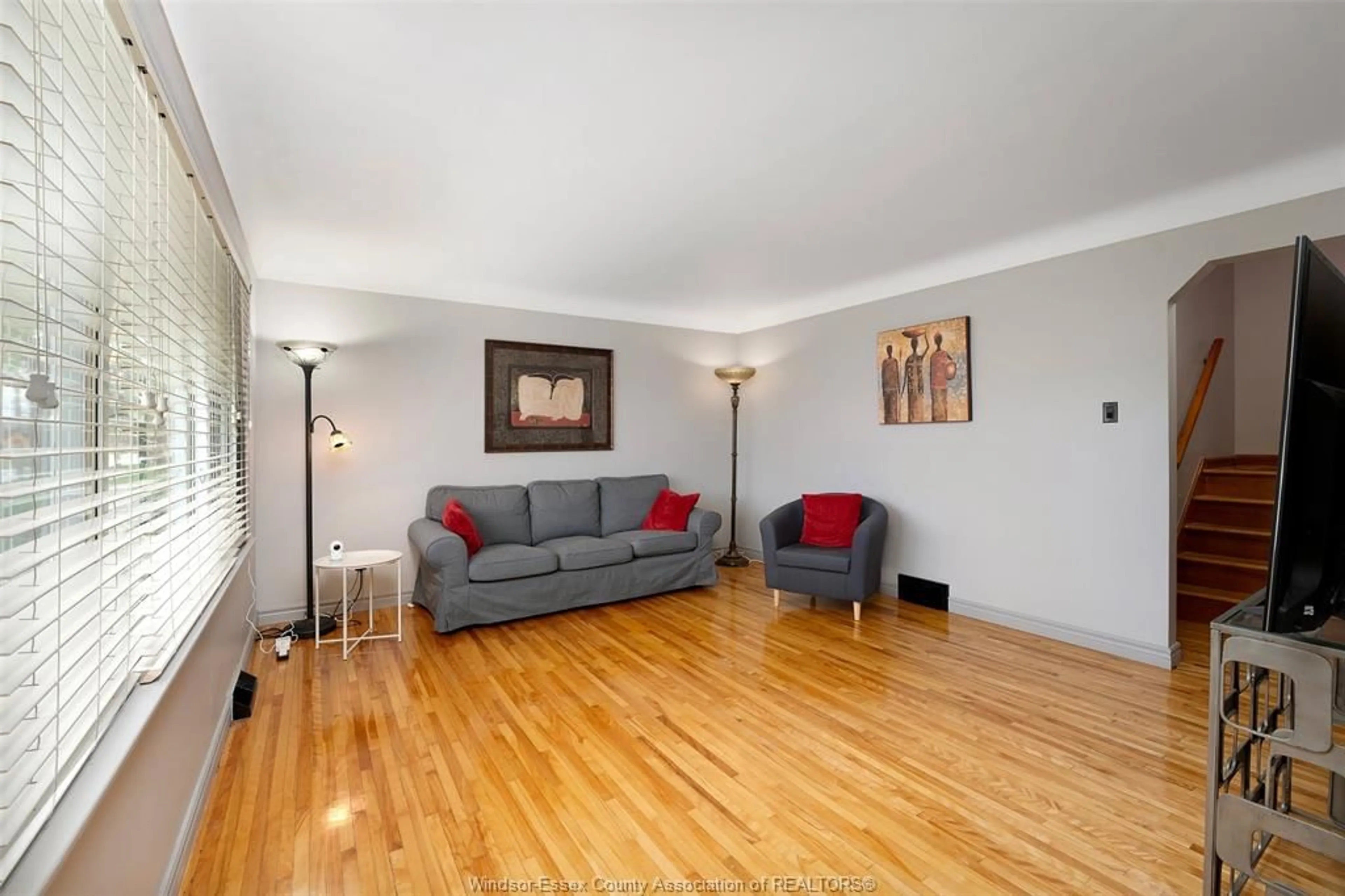 Living room with furniture, wood/laminate floor for 2575 Kildare Rd, Windsor Ontario N8W 2Y4