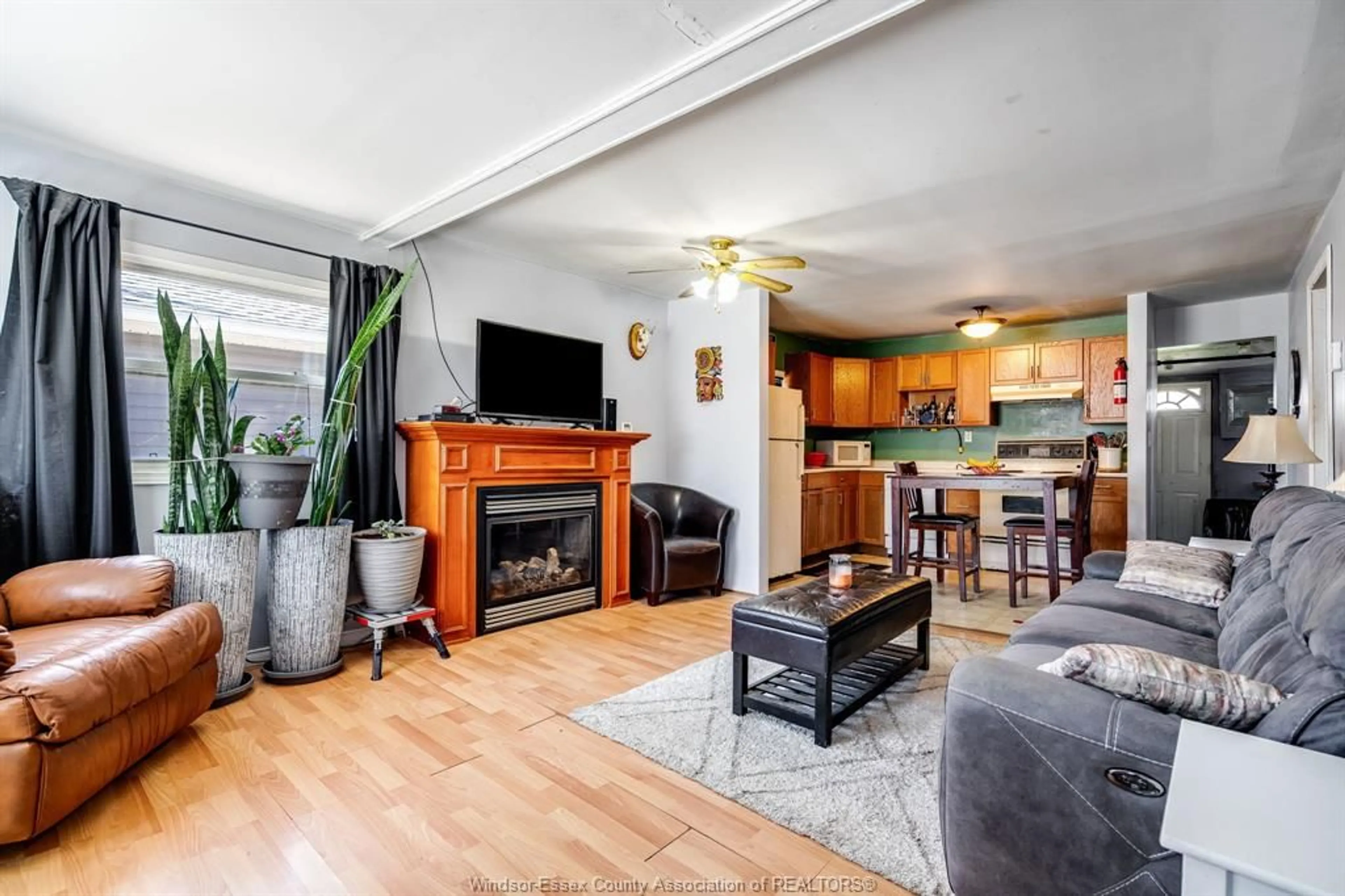 Living room with furniture, wood/laminate floor for 1044 Birch Ave, Kingsville Ontario N9Y 3V1