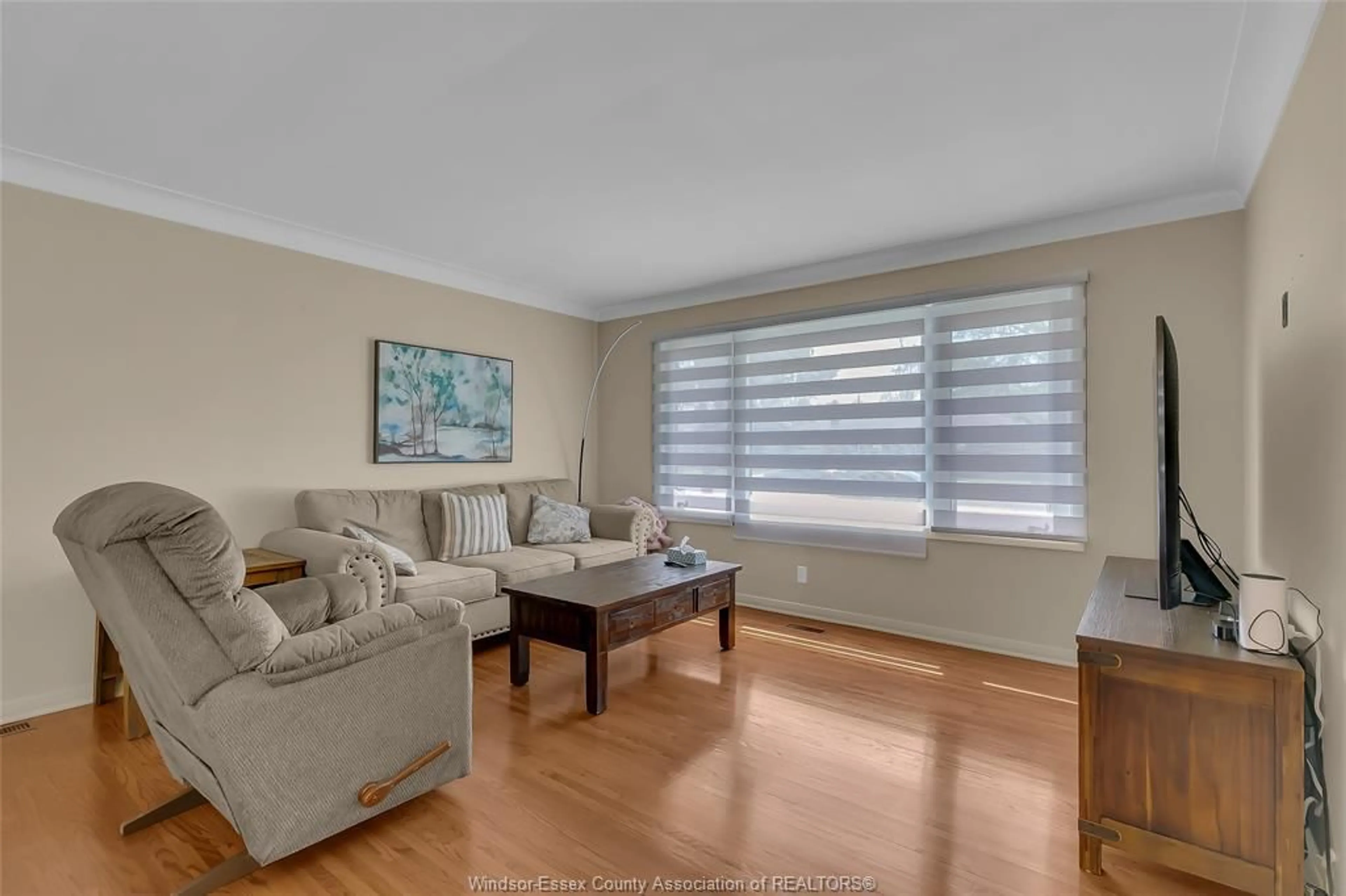 Living room with furniture, wood/laminate floor for 2930 Curry Ave, Windsor Ontario N9E 2Y1
