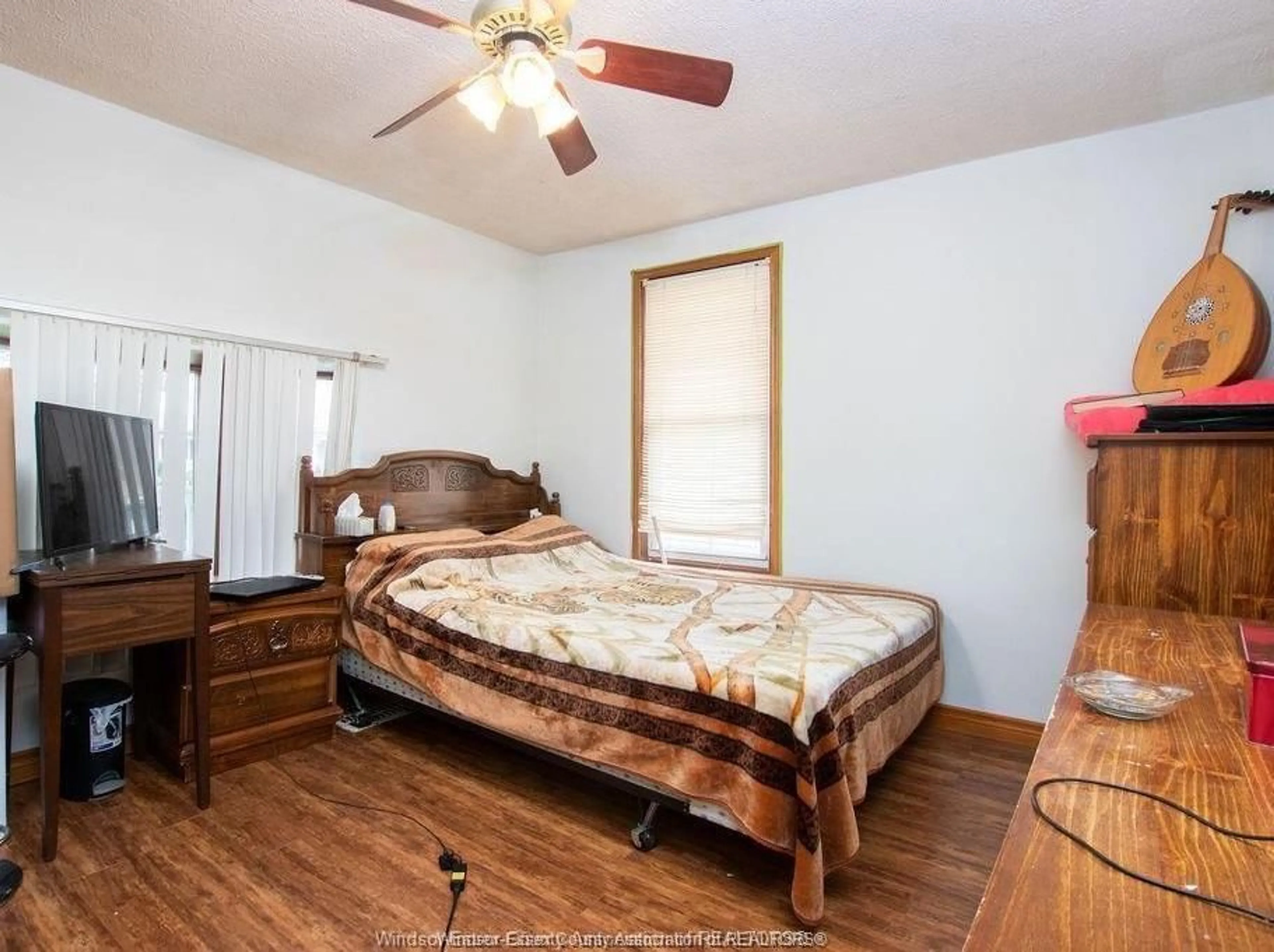 Bedroom with bed, wood/laminate floor for 819 LANGLOIS Ave, Windsor Ontario N9A 2G9