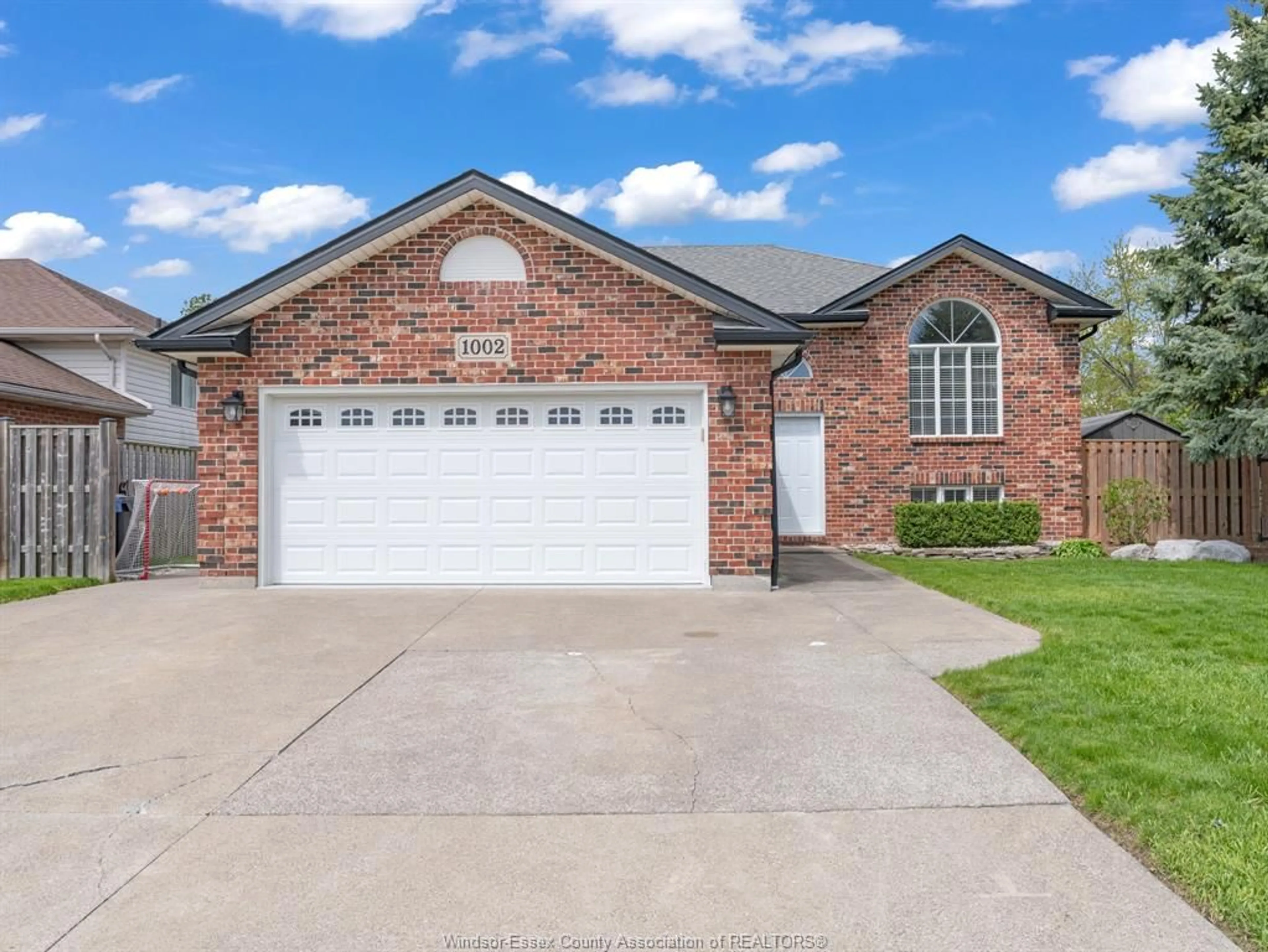 Home with brick exterior material, street for 1002 KING RICHARD Crt, Lakeshore Ontario N8L 0T8