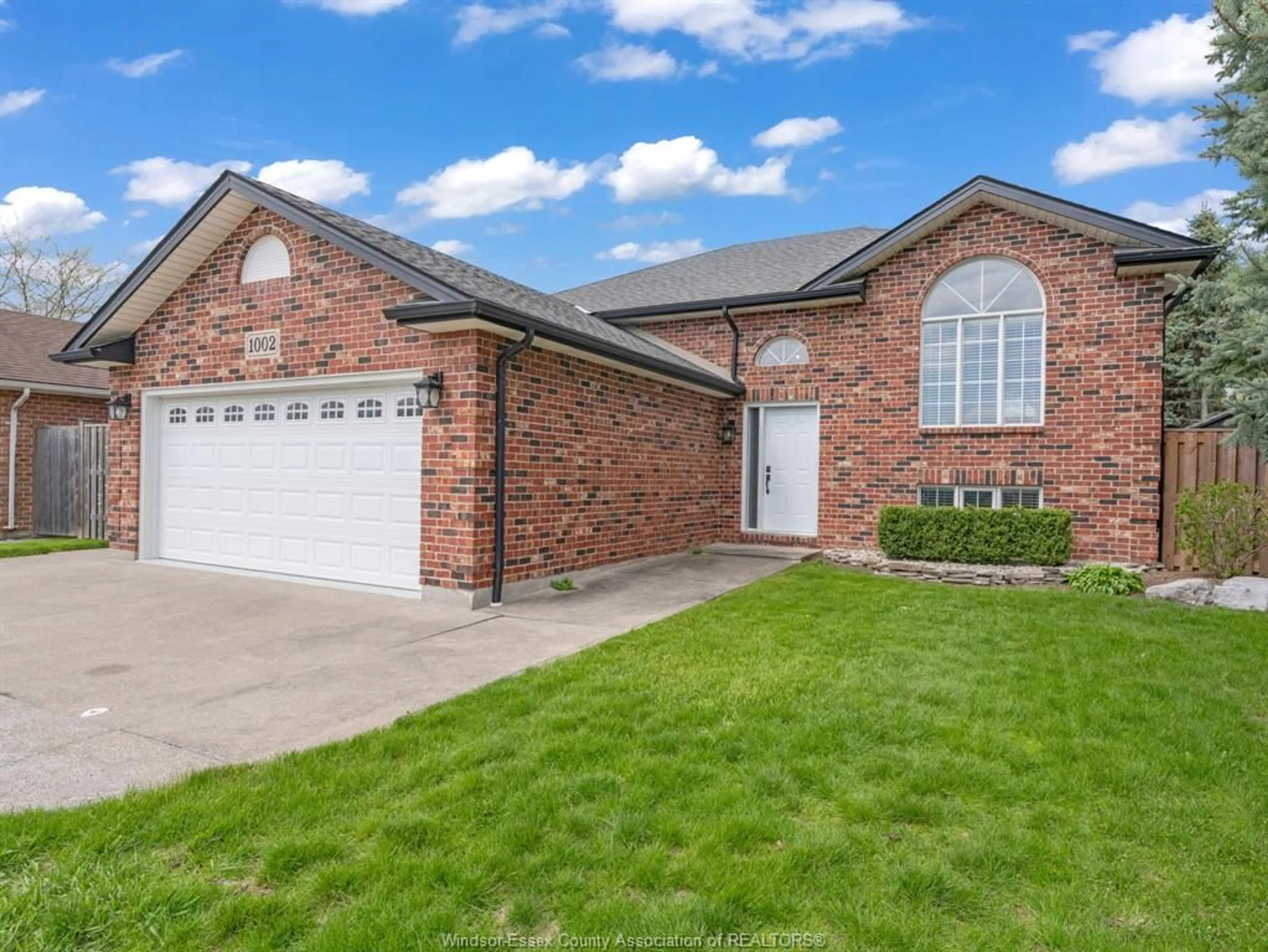 Home with brick exterior material, street for 1002 KING RICHARD Crt, Lakeshore Ontario N8L 0T8