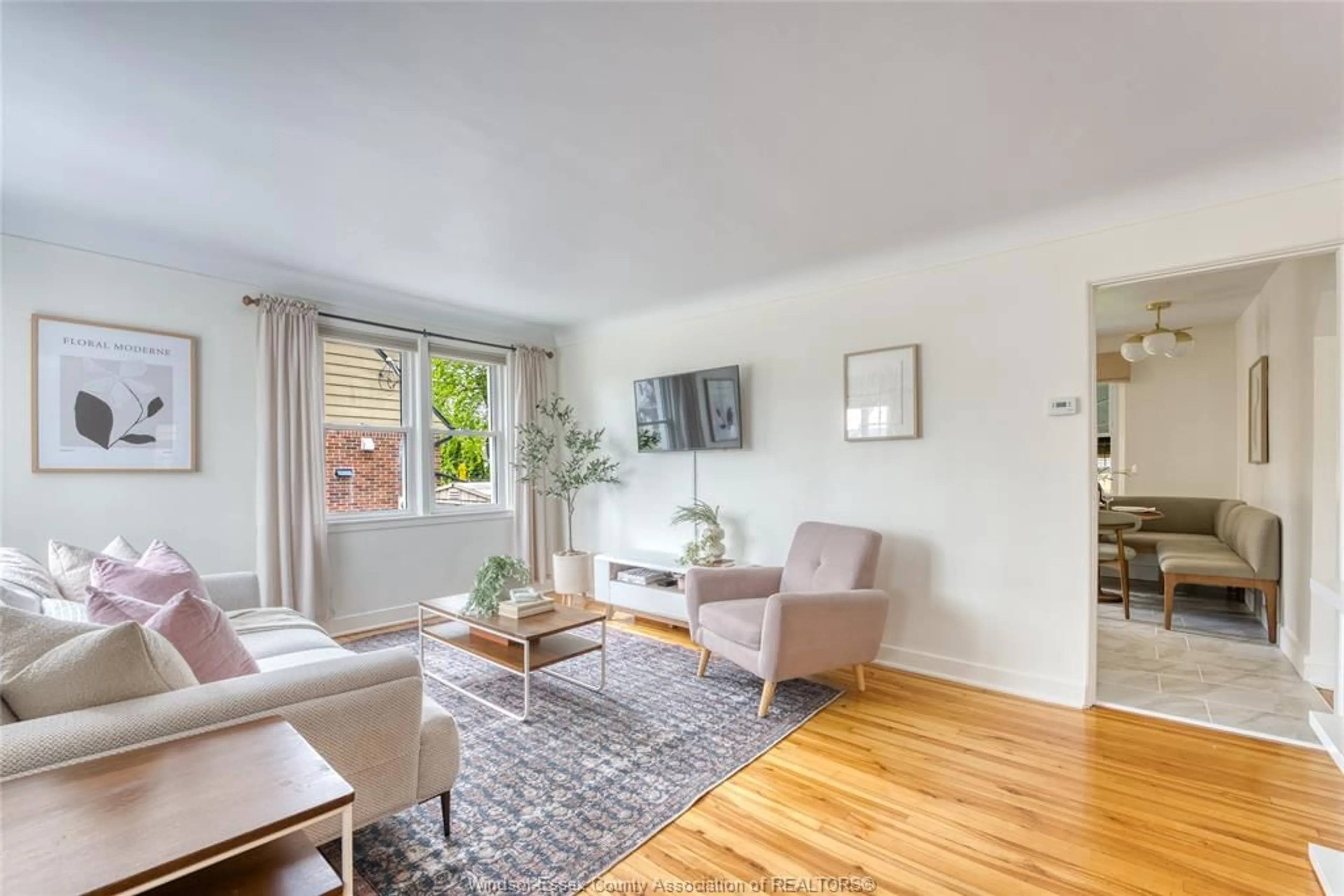 Living room with furniture, wood/laminate floor for 2431 CHILVER Rd, Windsor Ontario N8W 2V7