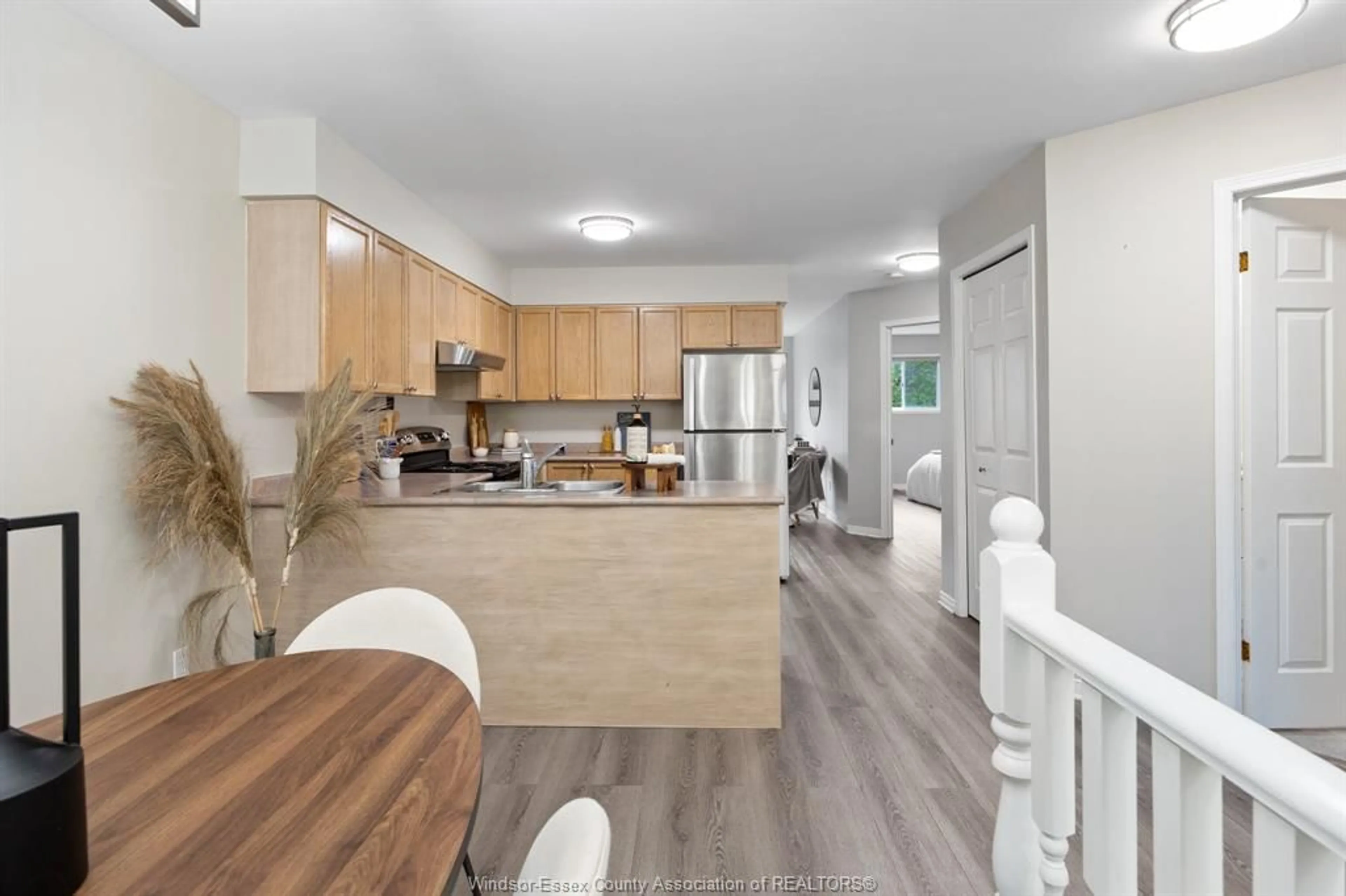 Open concept kitchen, wood/laminate floor for 1405 MICKAILA Cres, Tecumseh Ontario N8N 4Z2