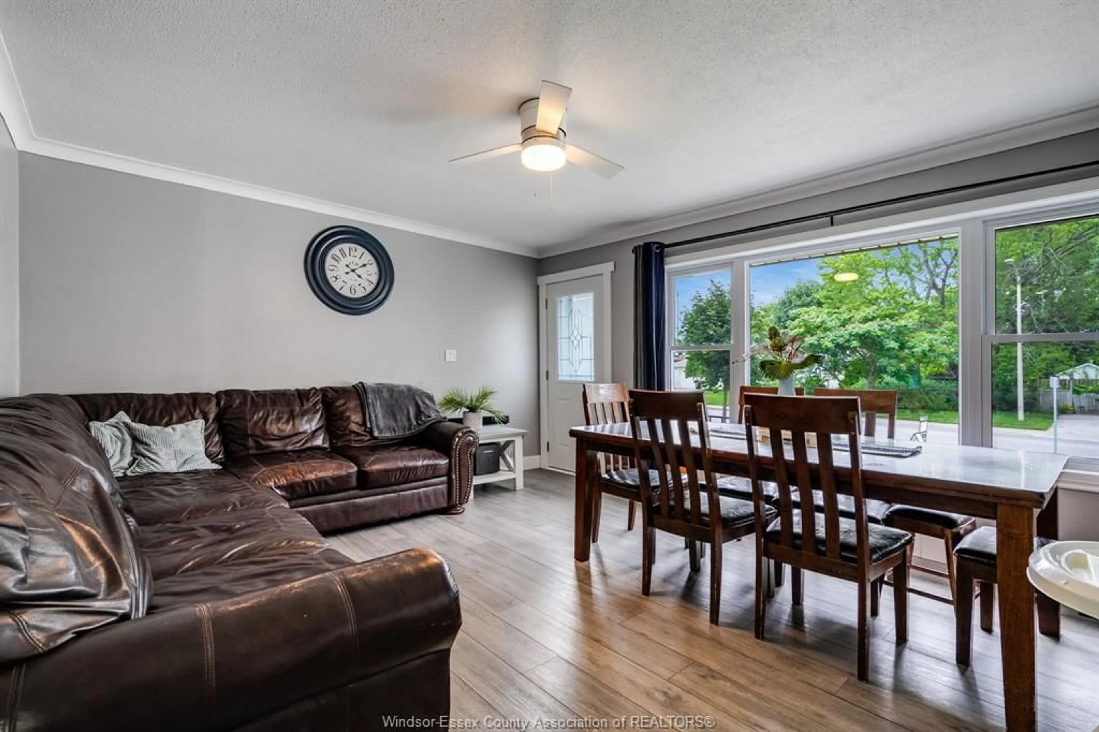 Living room with furniture, wood/laminate floor for 104 Danforth Ave, Leamington Ontario N8H 2R2