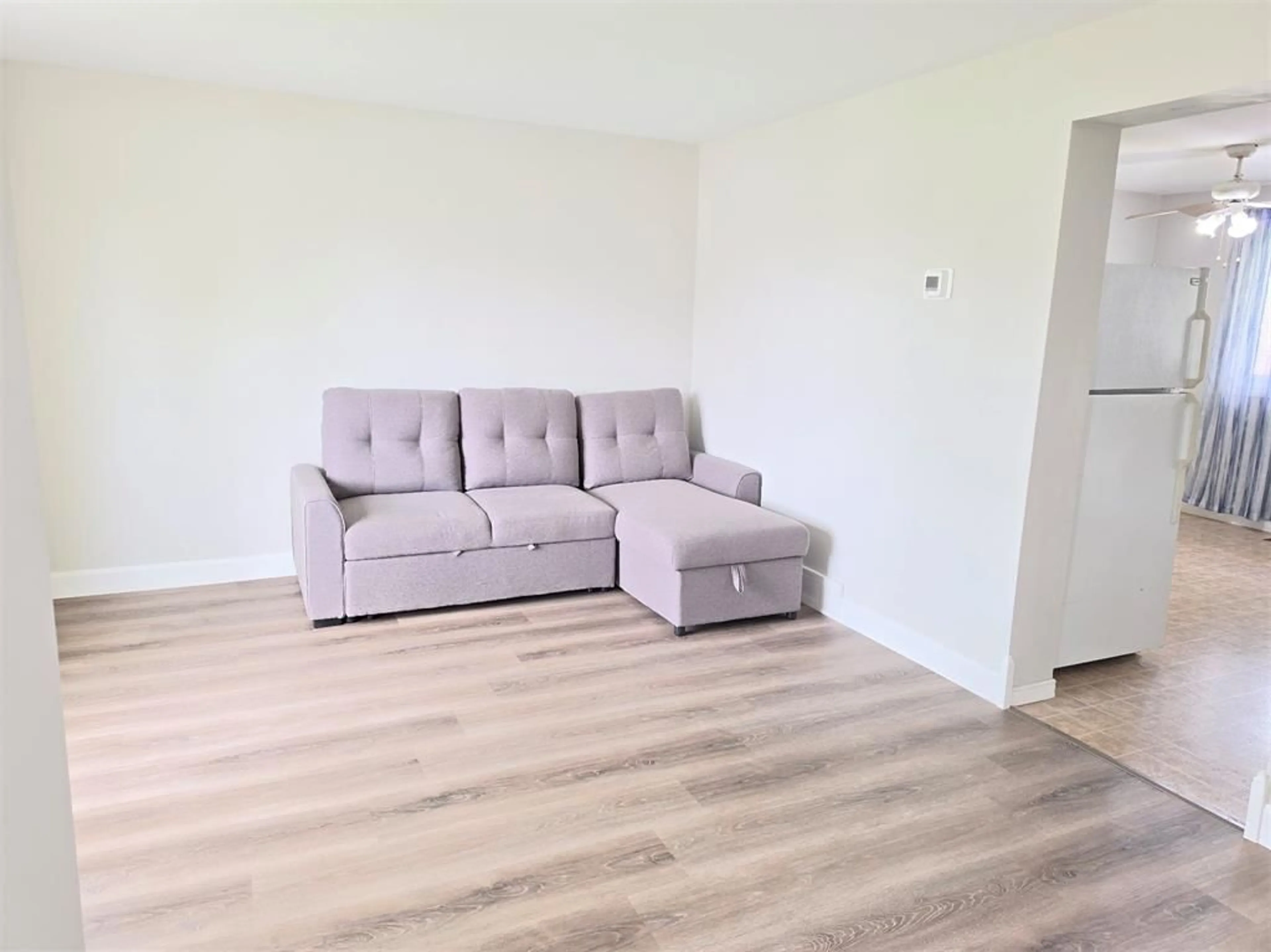 Living room with furniture, wood/laminate floor for 322 Somerset Cres, Sarnia Ontario N7S 4G1