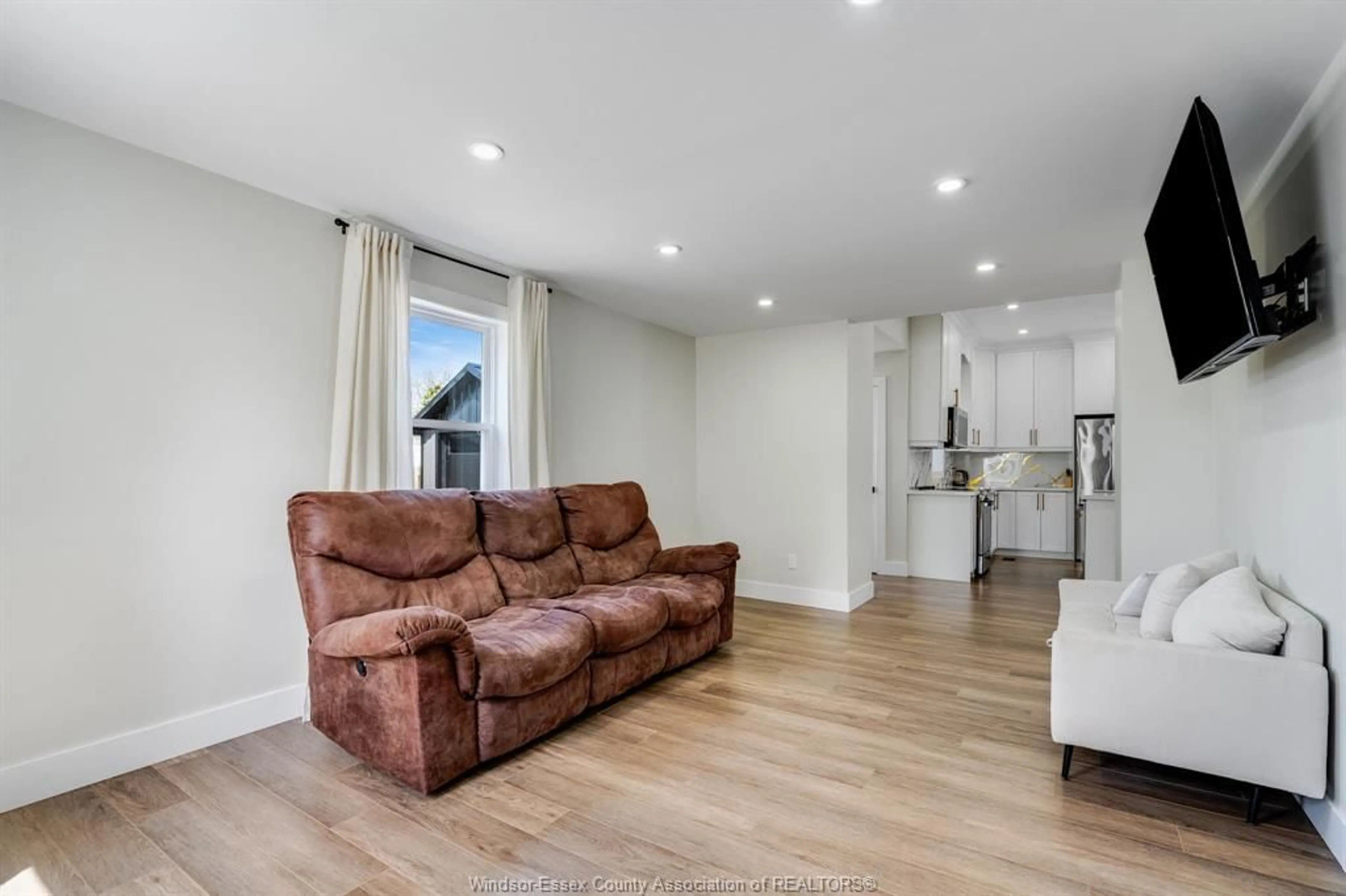 Living room with furniture, wood/laminate floor for 23 Buchanan St, Wheatley Ontario N0P 2P0