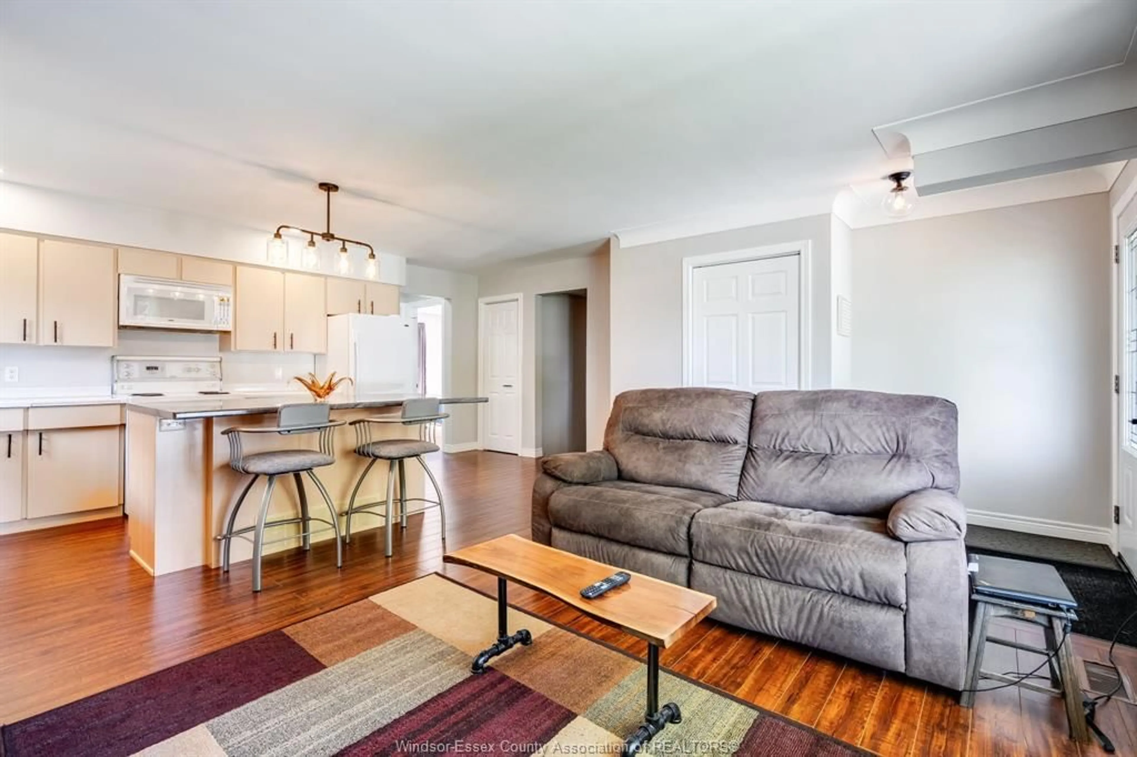 Living room with furniture, wood/laminate floor for 11 Lutsch St, Leamington Ontario N8H 4K3
