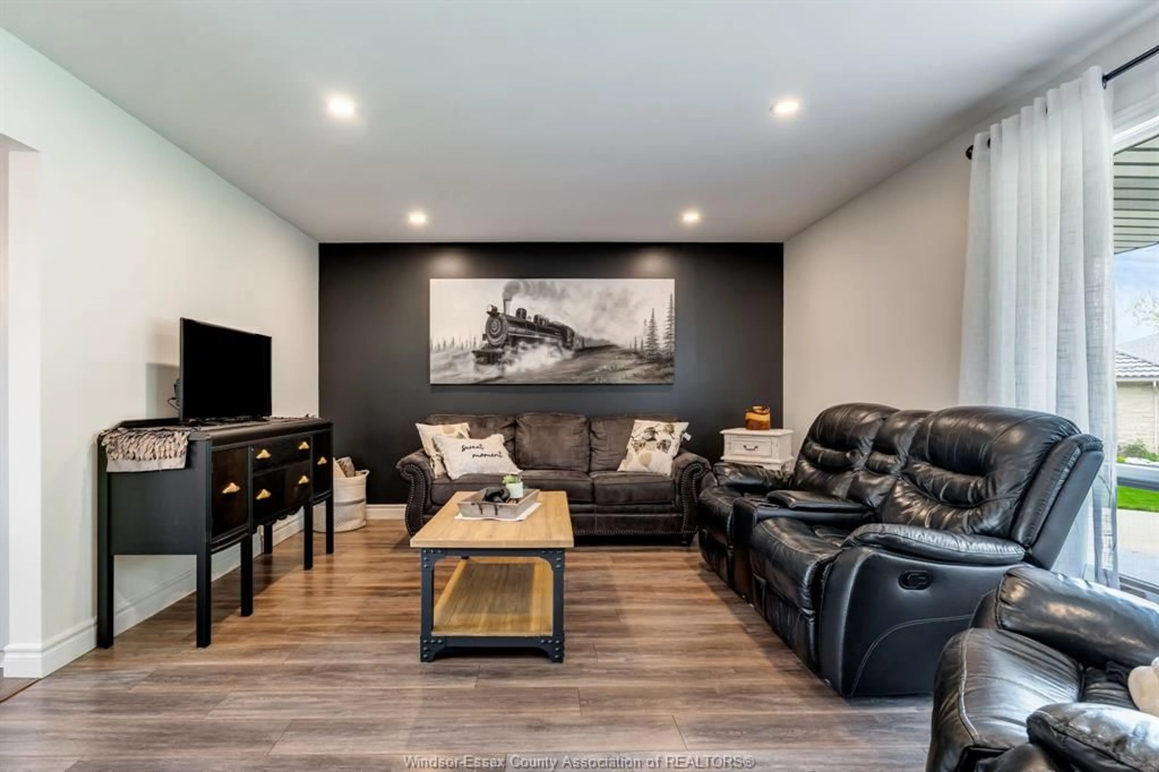 Living room with furniture, wood/laminate floor for 66 Shawnee Crt, Leamington Ontario N8H 5A9
