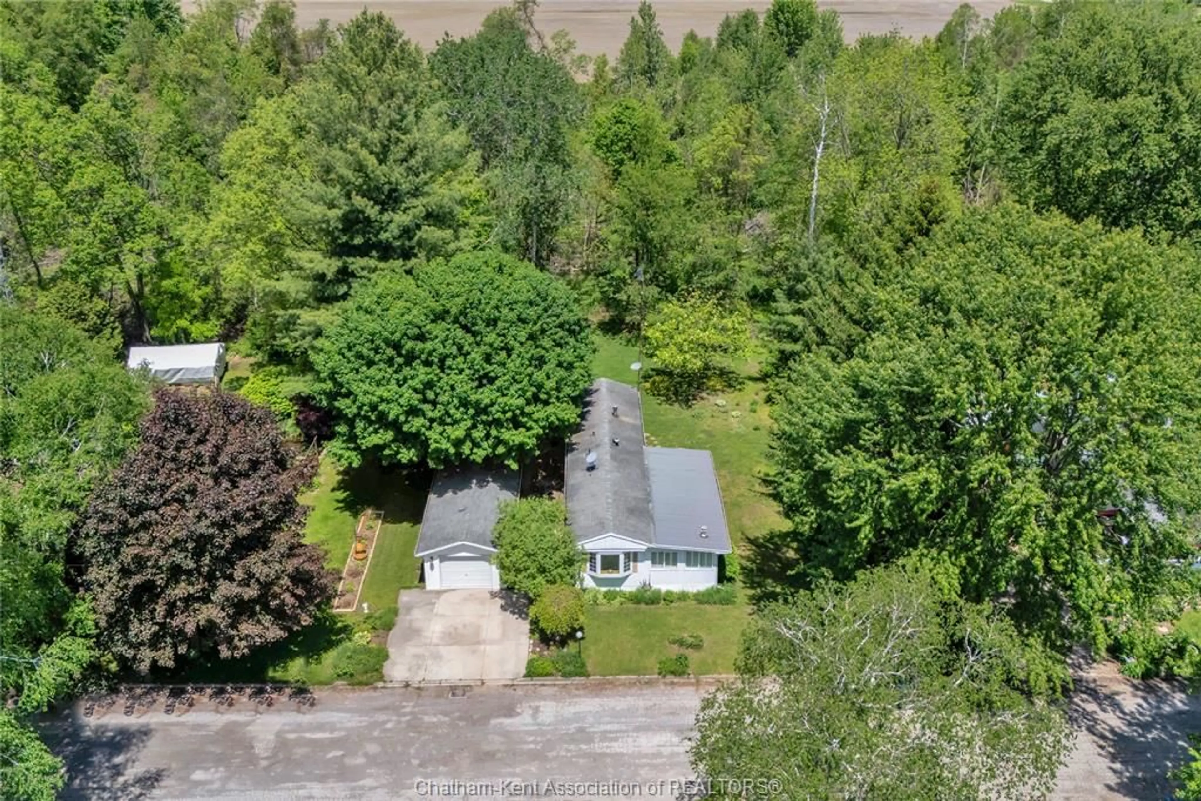 A pic from outside/outdoor area/front of a property/back of a property/a pic from drone, forest/trees view for 29338 Jane Rd #95, Chatham-Kent Ontario N0P 2K0