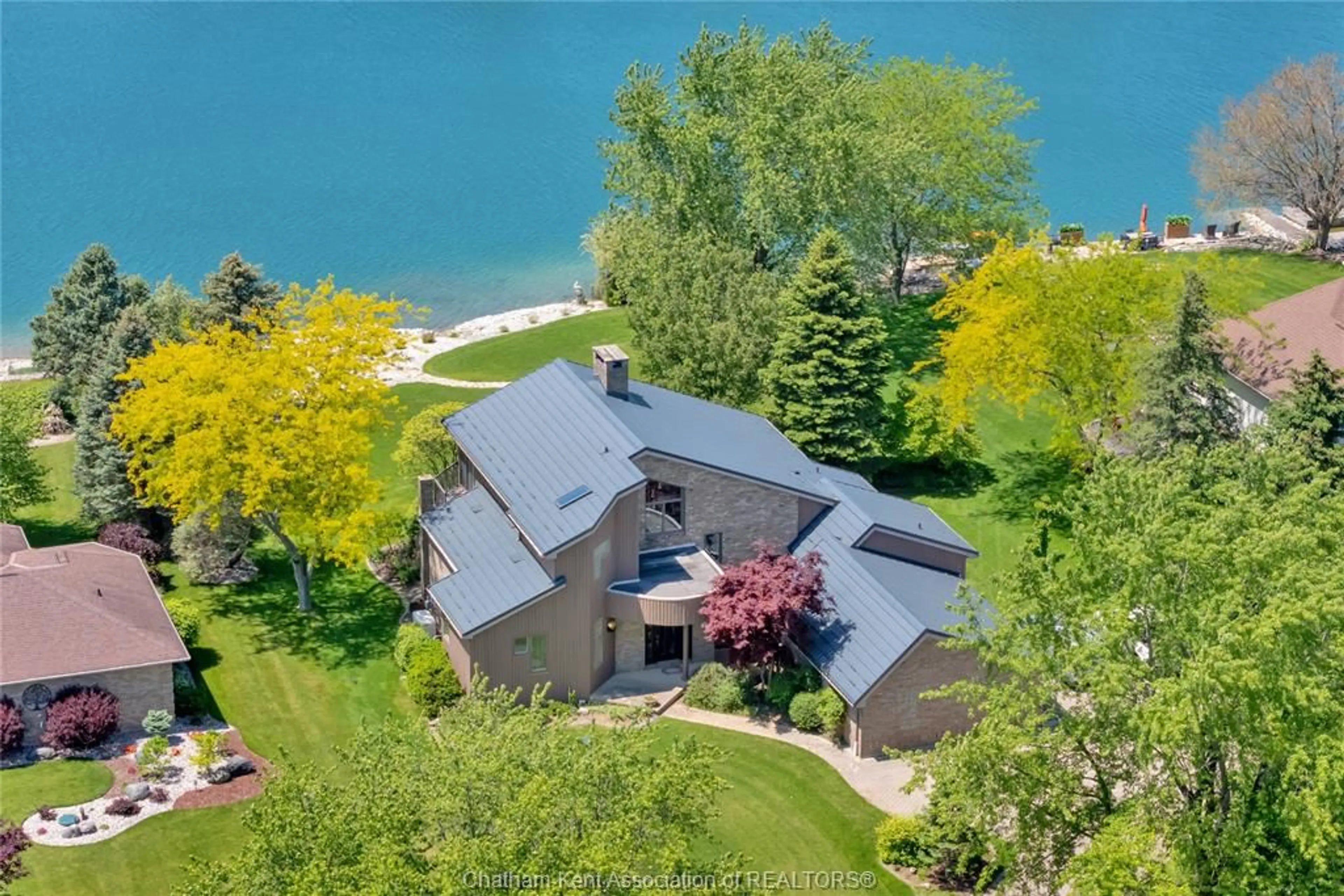 A pic from outside/outdoor area/front of a property/back of a property/a pic from drone, water/lake/river/ocean view for 10691 Lakeview Dr, Chatham Ontario N7M 5J3