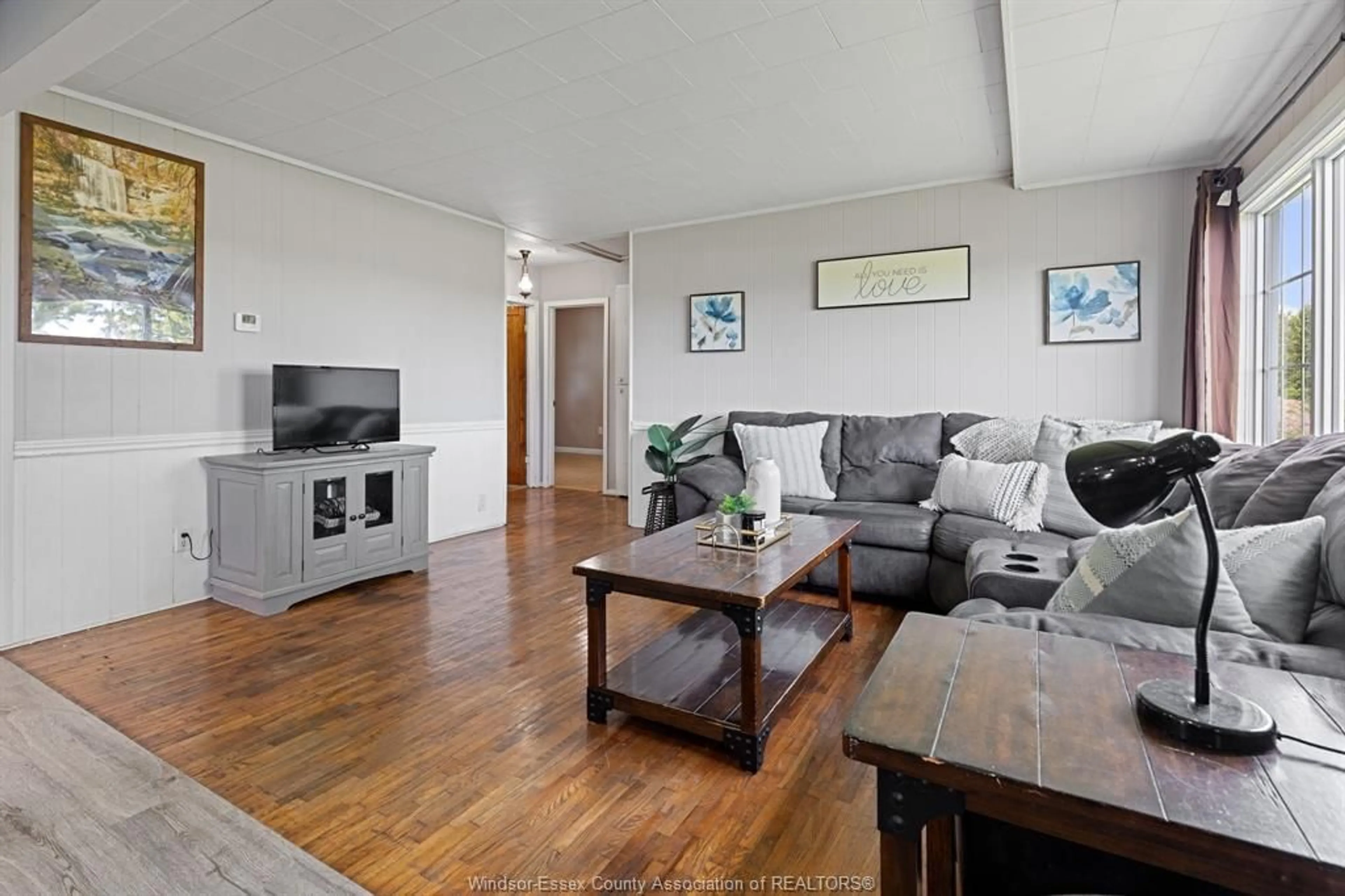 Living room with furniture, wood/laminate floor for 17825 LAKESHORE RD 303, Tilbury North Ontario N0P 2L0