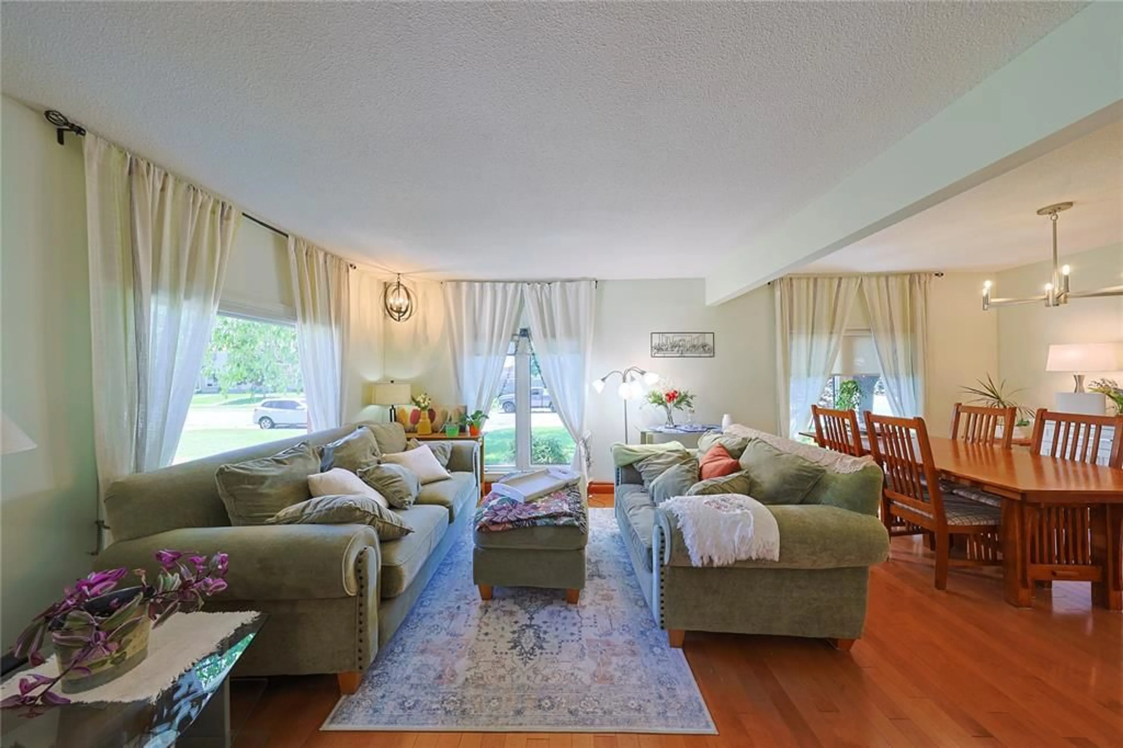 Living room with furniture, wood/laminate floor for 22 Turner Dr, Sarnia Ontario N7S 4L1