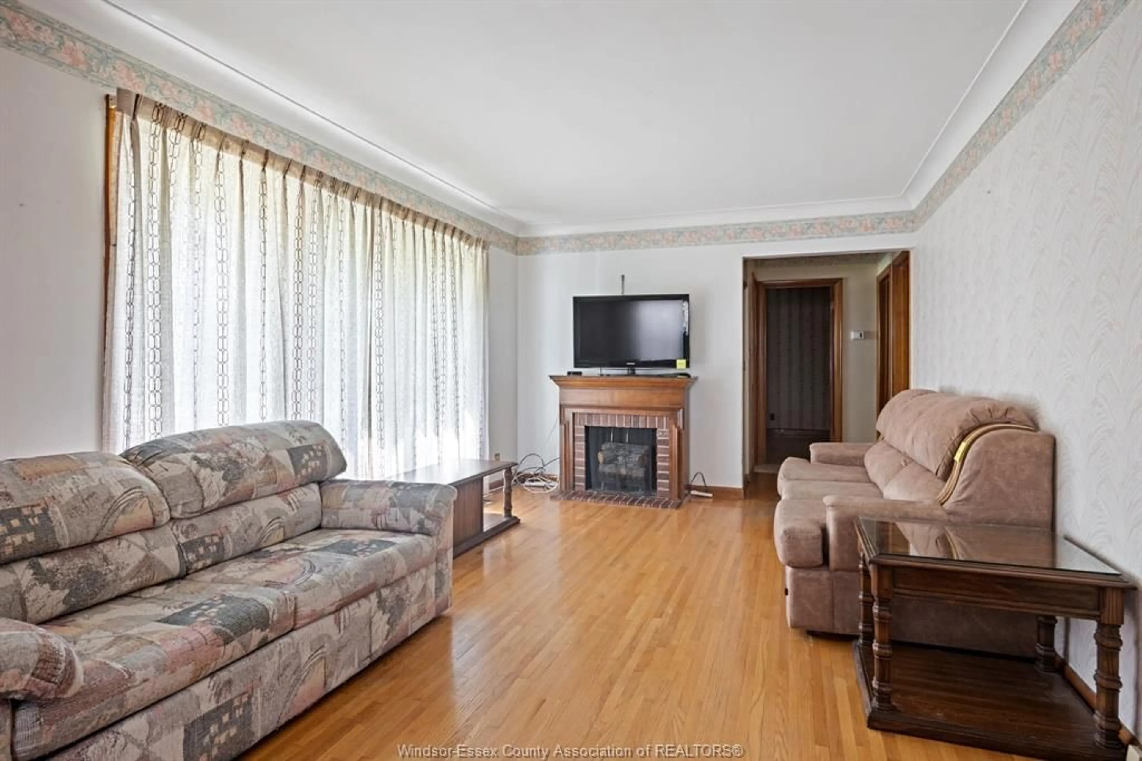 Living room with furniture, wood/laminate floor for 371 ST. MARKS, Tecumseh Ontario N8N 2H6