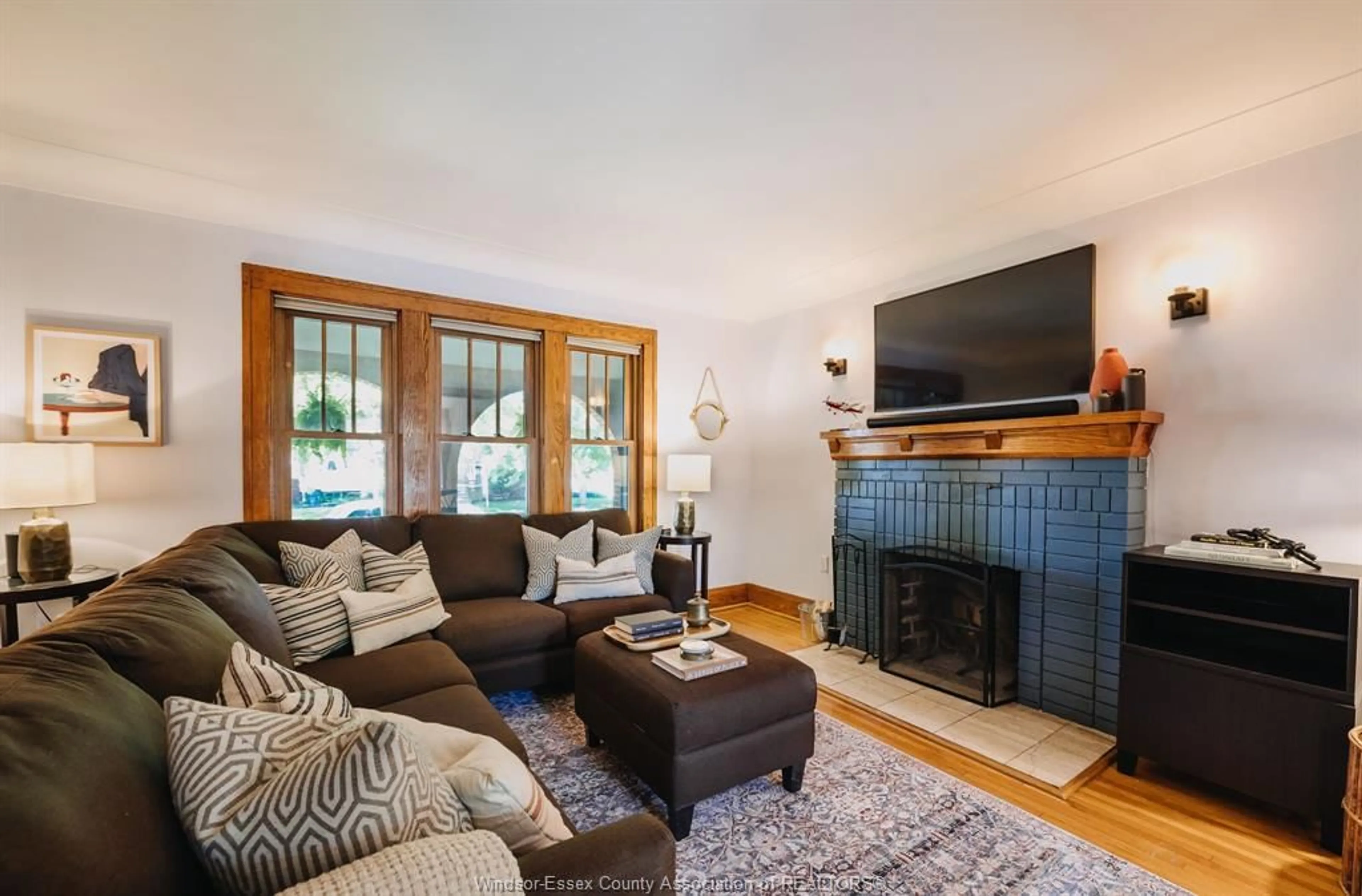 Living room with furniture, wood/laminate floor for 1249 Moy Ave, Windsor Ontario N8X 4S4