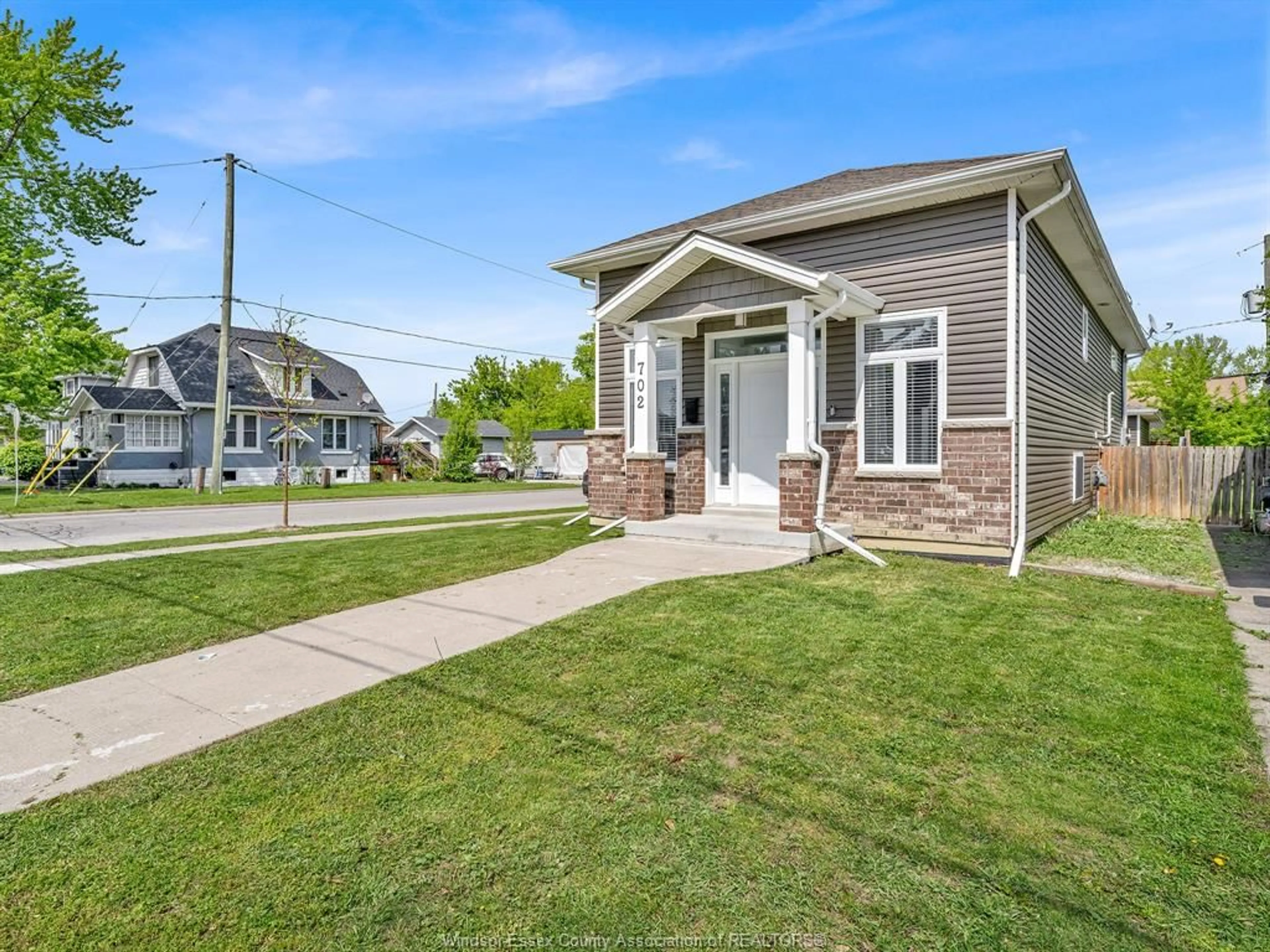 Home with vinyl exterior material, street for 702 LESPERANCE Rd, Tecumseh Ontario N8N 1W7