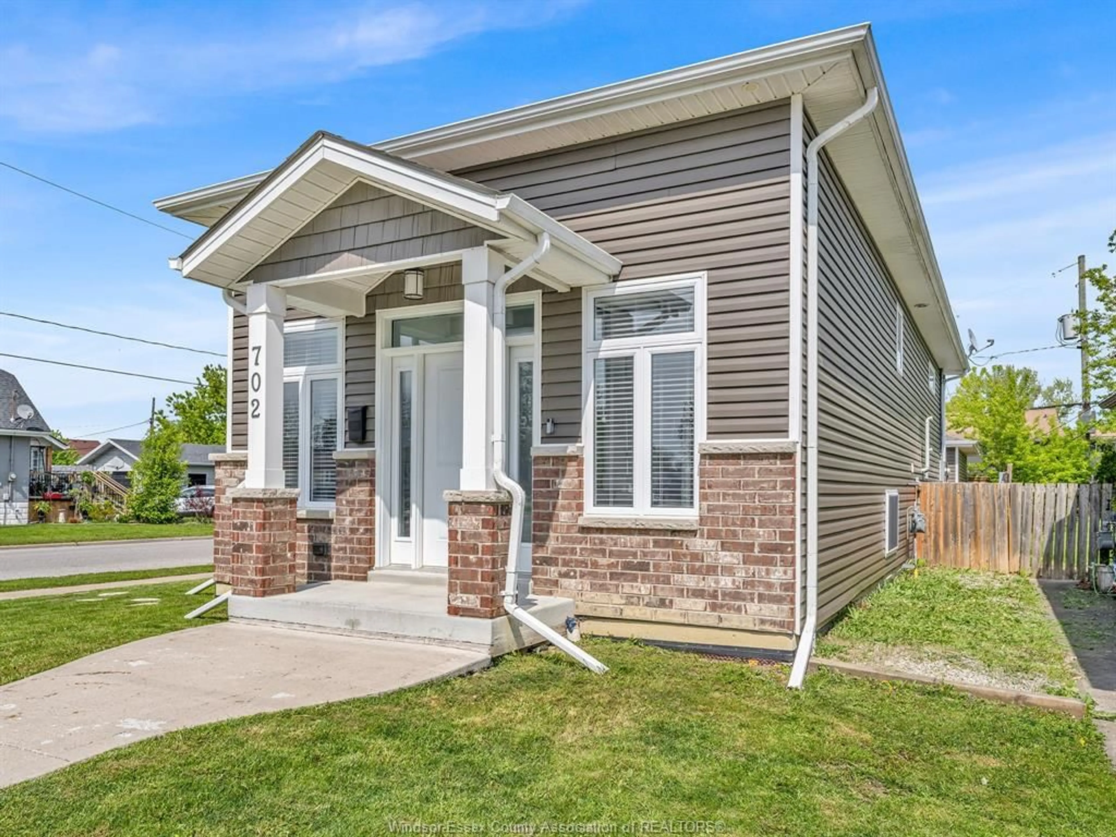Home with vinyl exterior material, street for 702 LESPERANCE Rd, Tecumseh Ontario N8N 1W7