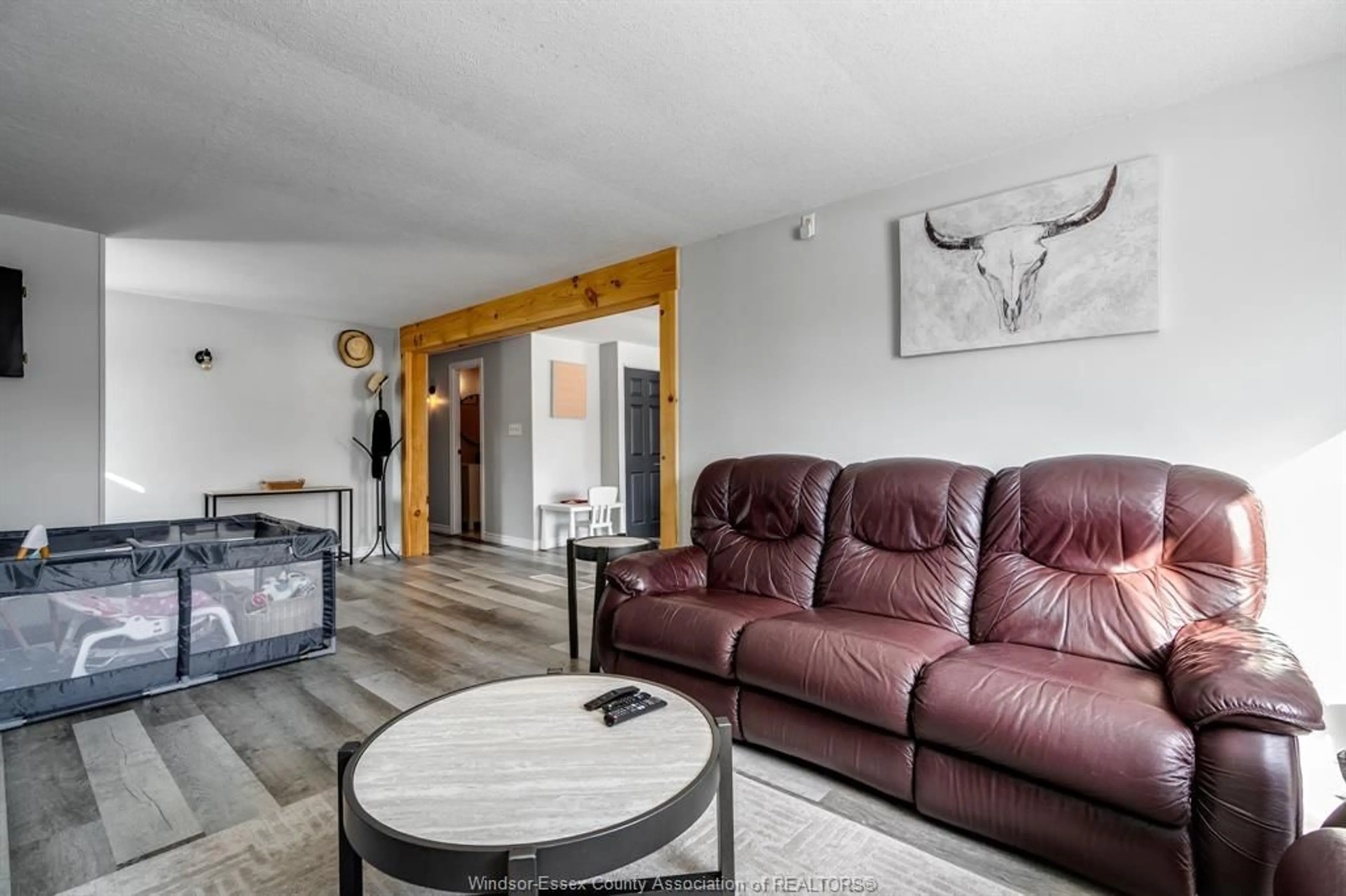 Living room with furniture, wood/laminate floor for 302 Summerset Ave, Kingsville Ontario N9Y 2B9