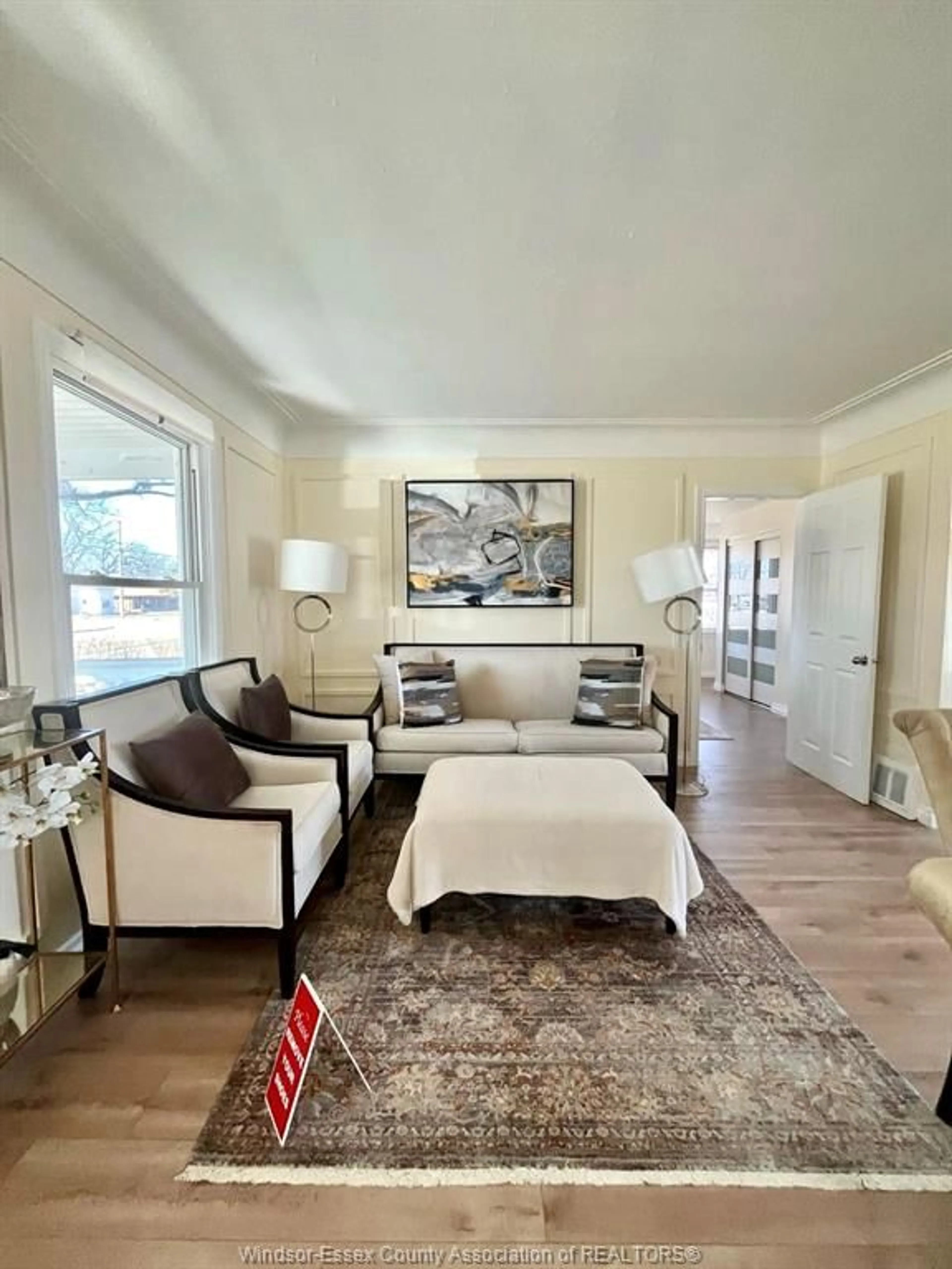 Living room with furniture, wood/laminate floor for 630 Lesperance Rd, Tecumseh Ontario N8N 1W6