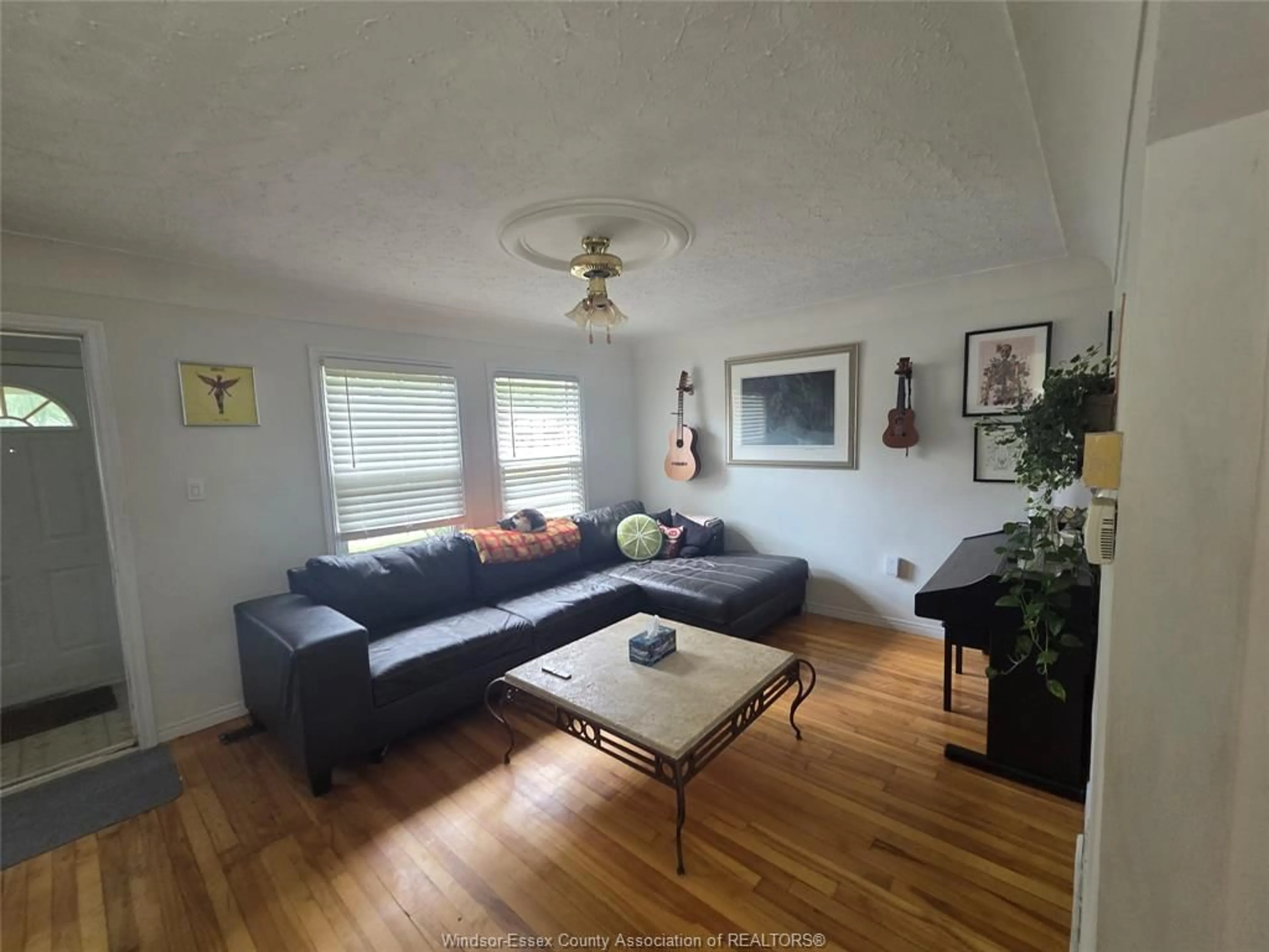 Living room with furniture, wood/laminate floor for 3425 HARRIS, Windsor Ontario N9C 1N6