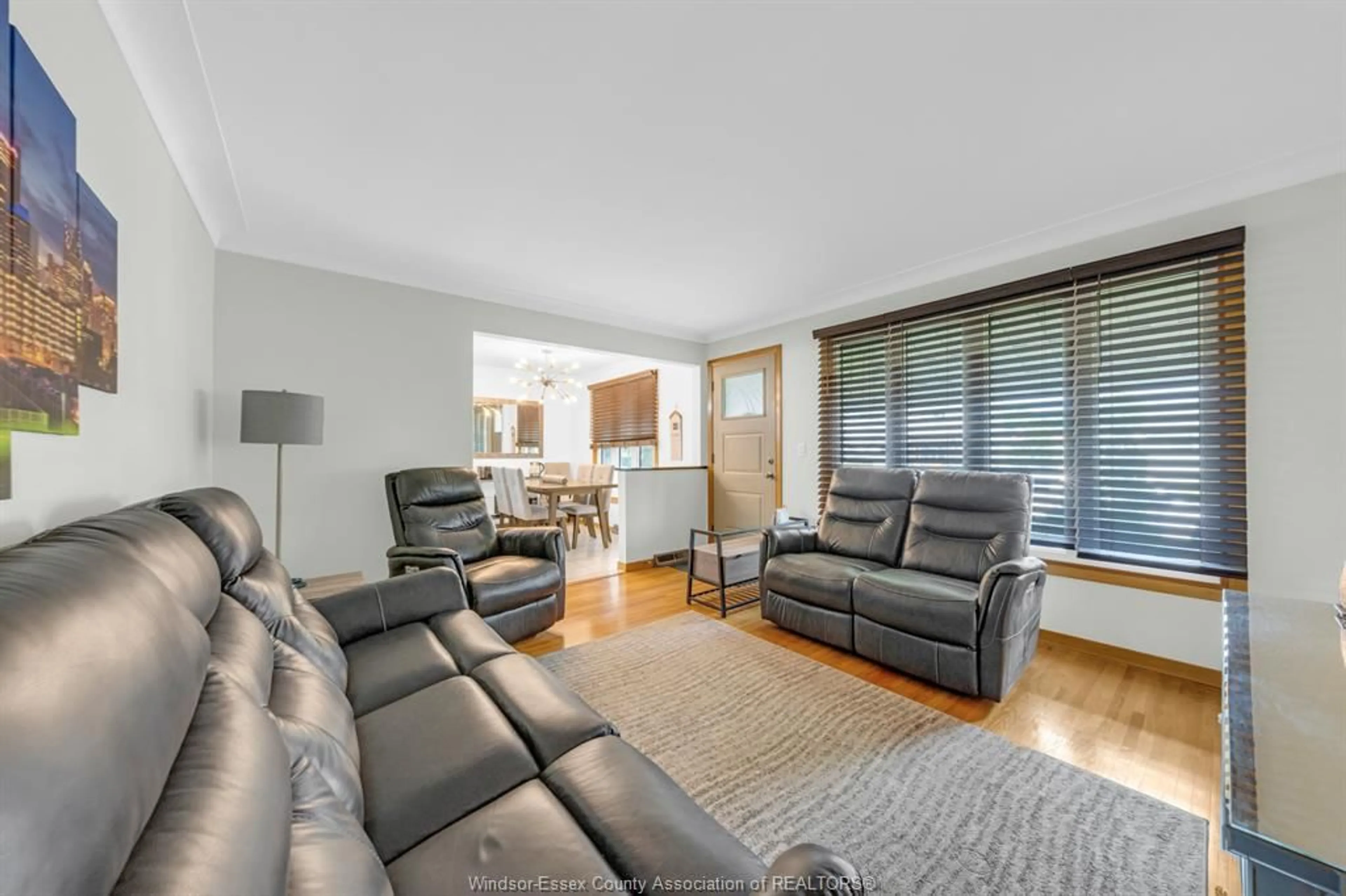 Living room with furniture, wood/laminate floor for 2471 CHANDLER Rd, Windsor Ontario N8W 4A7
