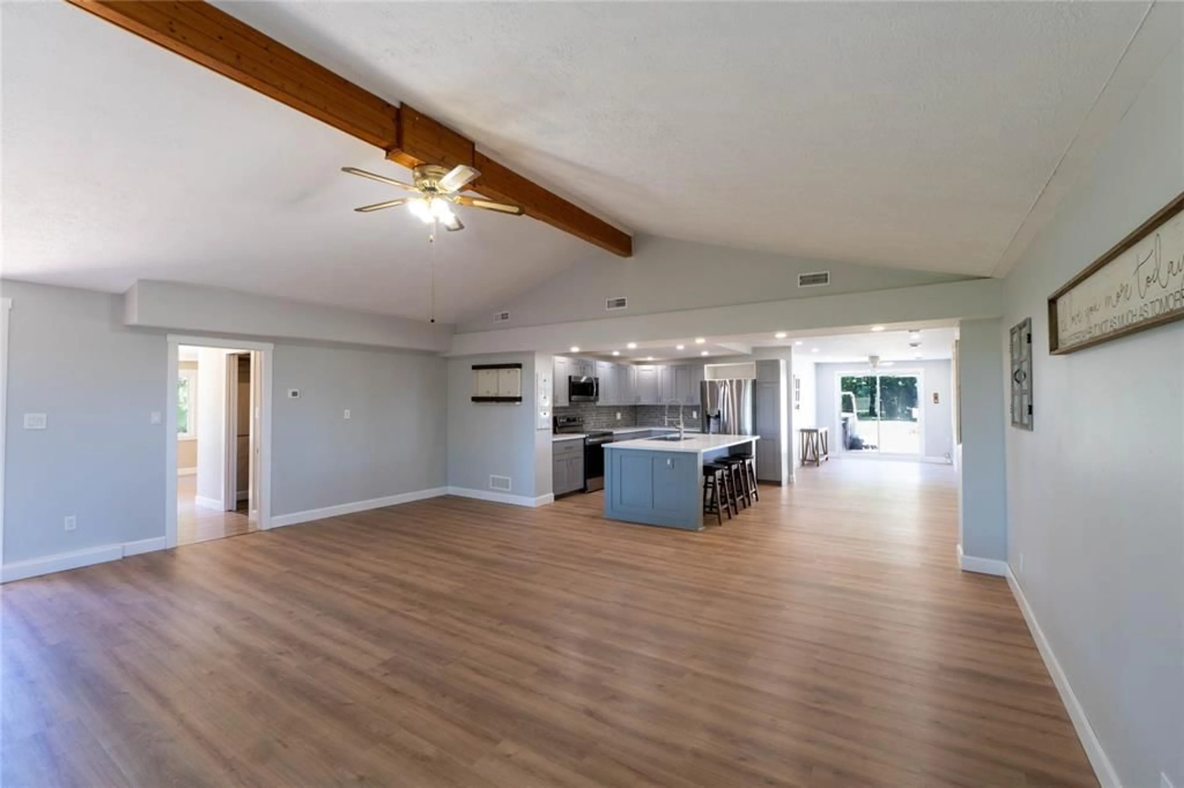 Open concept kitchen, wood/laminate floor for 5509 Stewart Line, Wallaceburg Ontario N8A 4L1