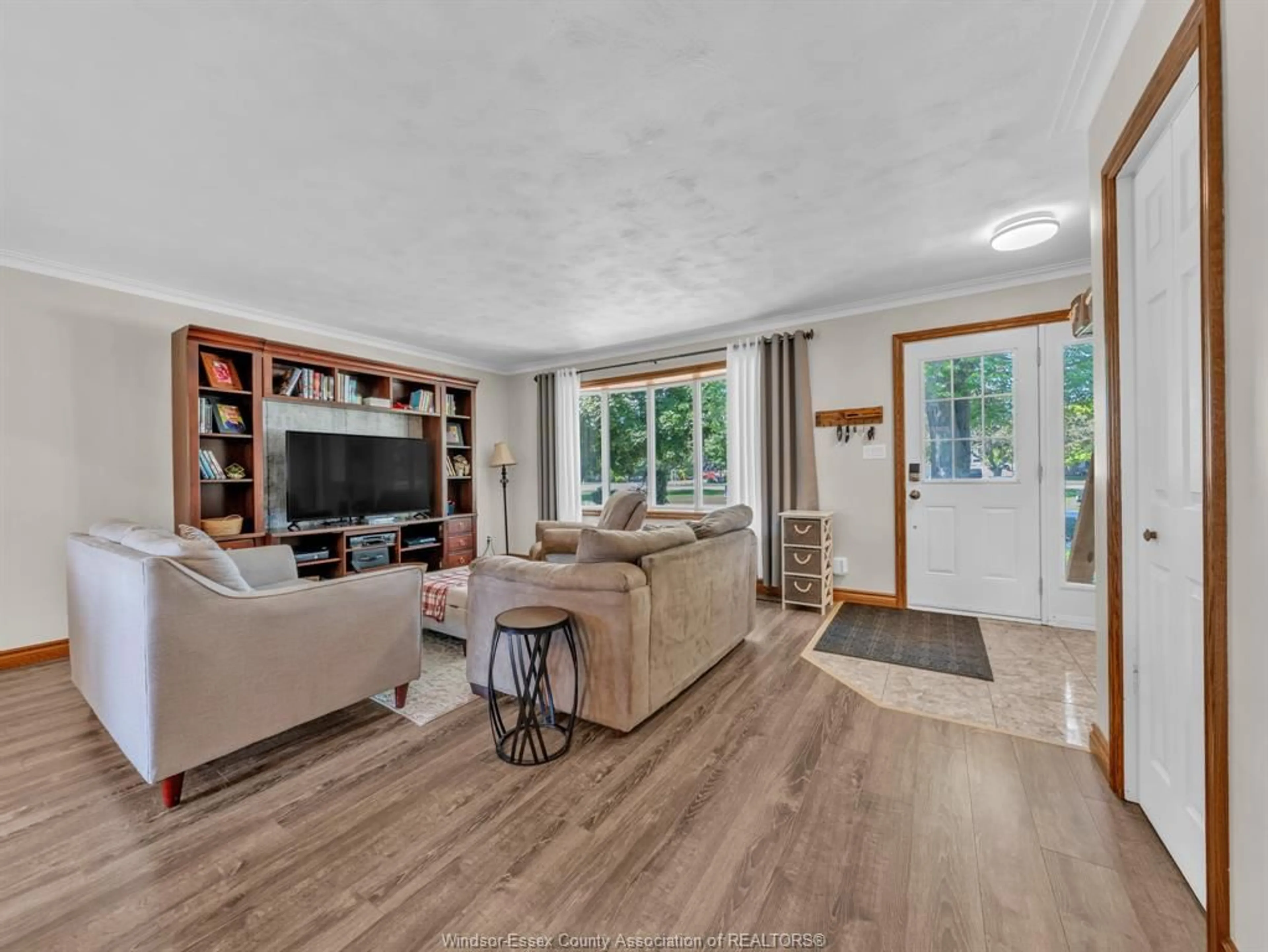 Living room with furniture, wood/laminate floor for 1828 Service Rd, Kingsville Ontario N0P 2G0