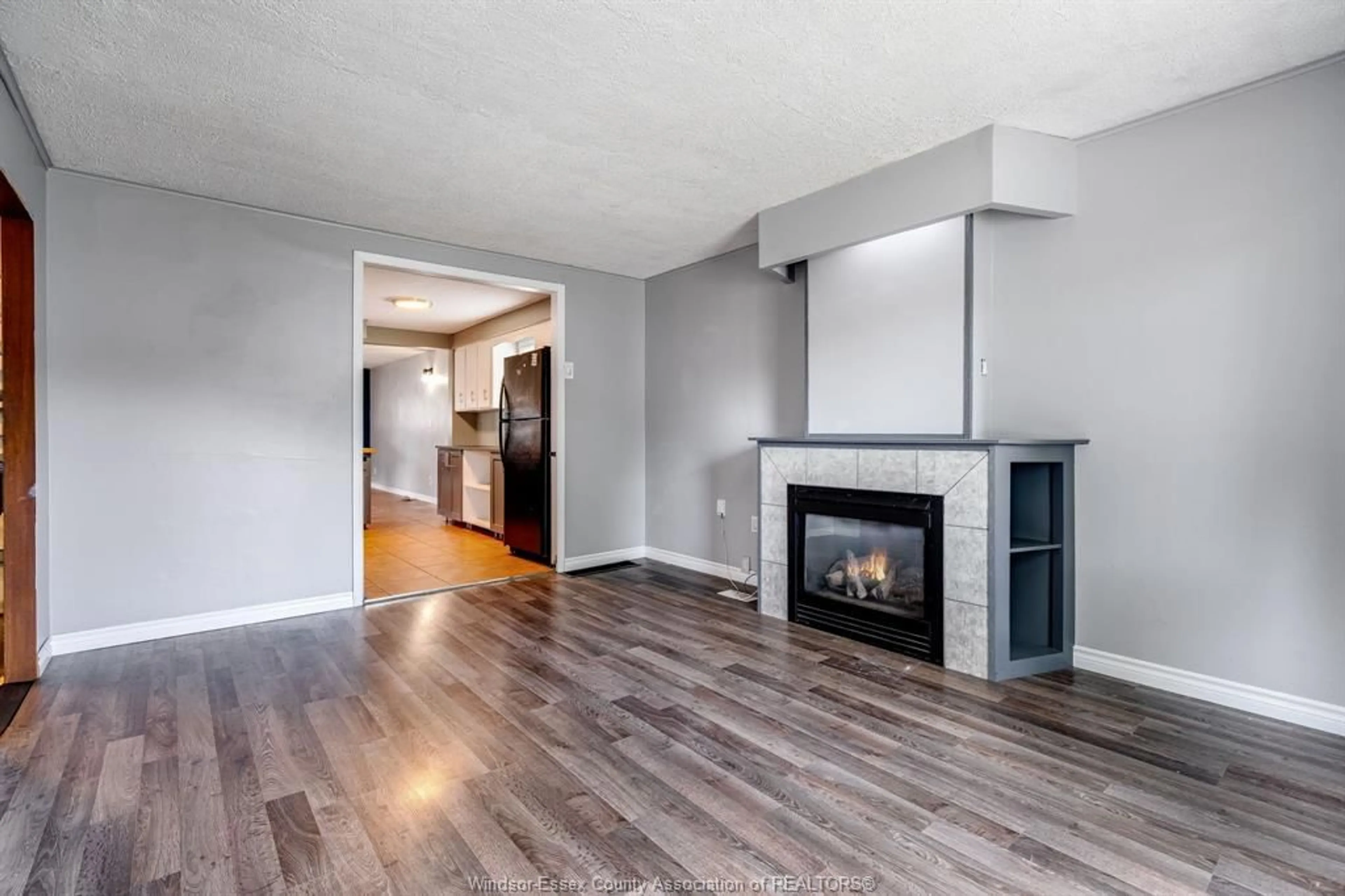 Living room with furniture, wood/laminate floor for 3793 Vaughan, Windsor Ontario N9C 1Z6