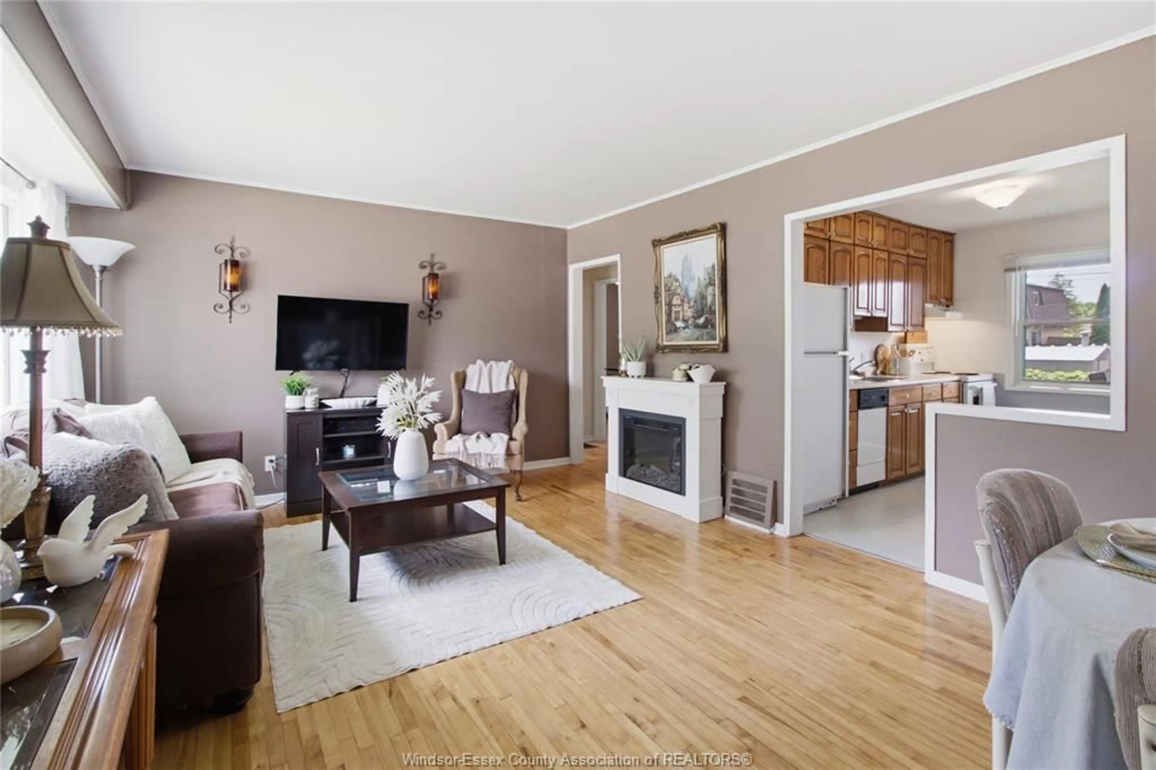 Living room with furniture, wood/laminate floor for 1677 Norman Rd, Windsor Ontario N8Y 4N6