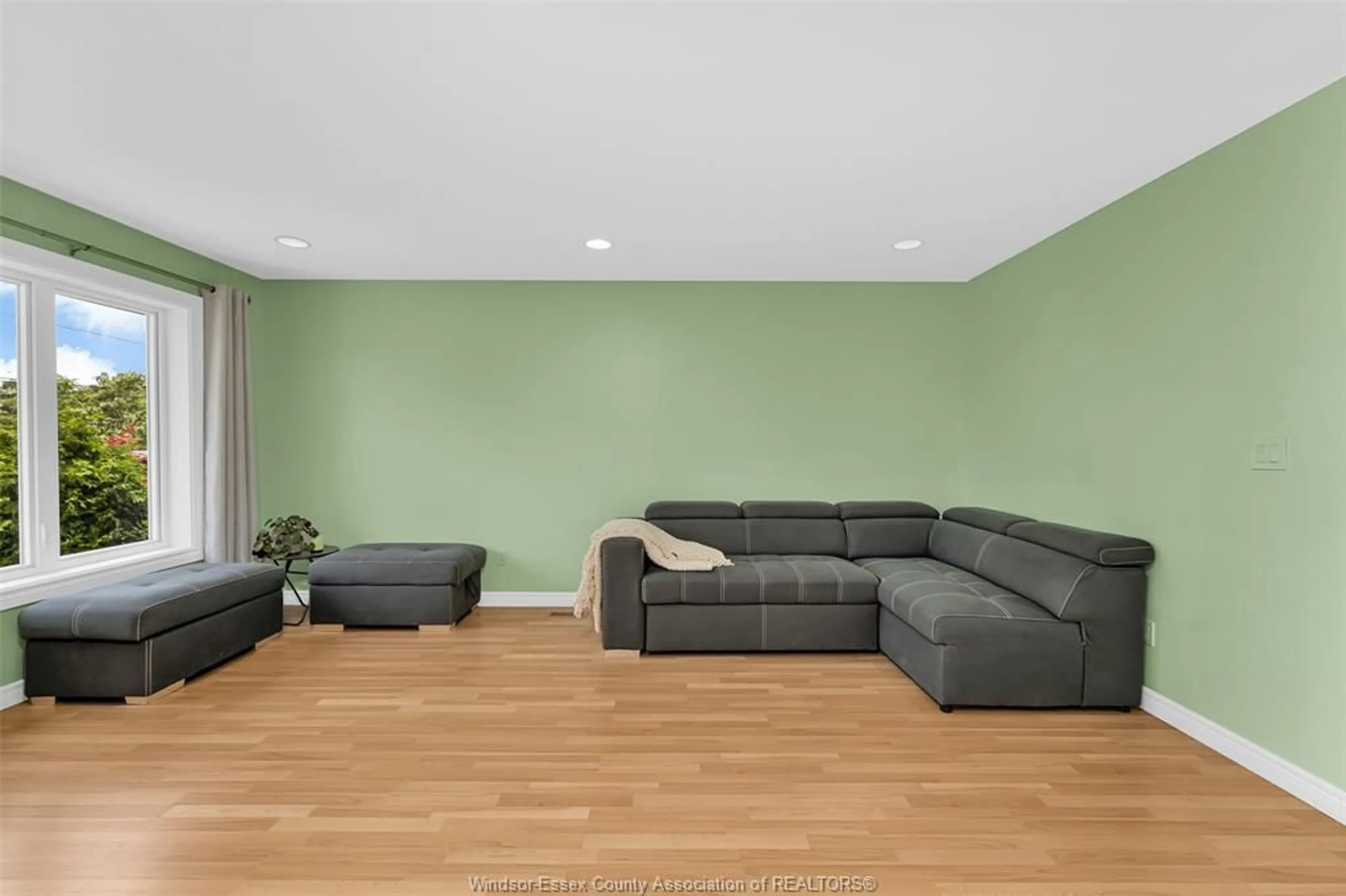 Living room with furniture, wood/laminate floor for 714 CABANA Rd, Windsor Ontario N9G 1A4