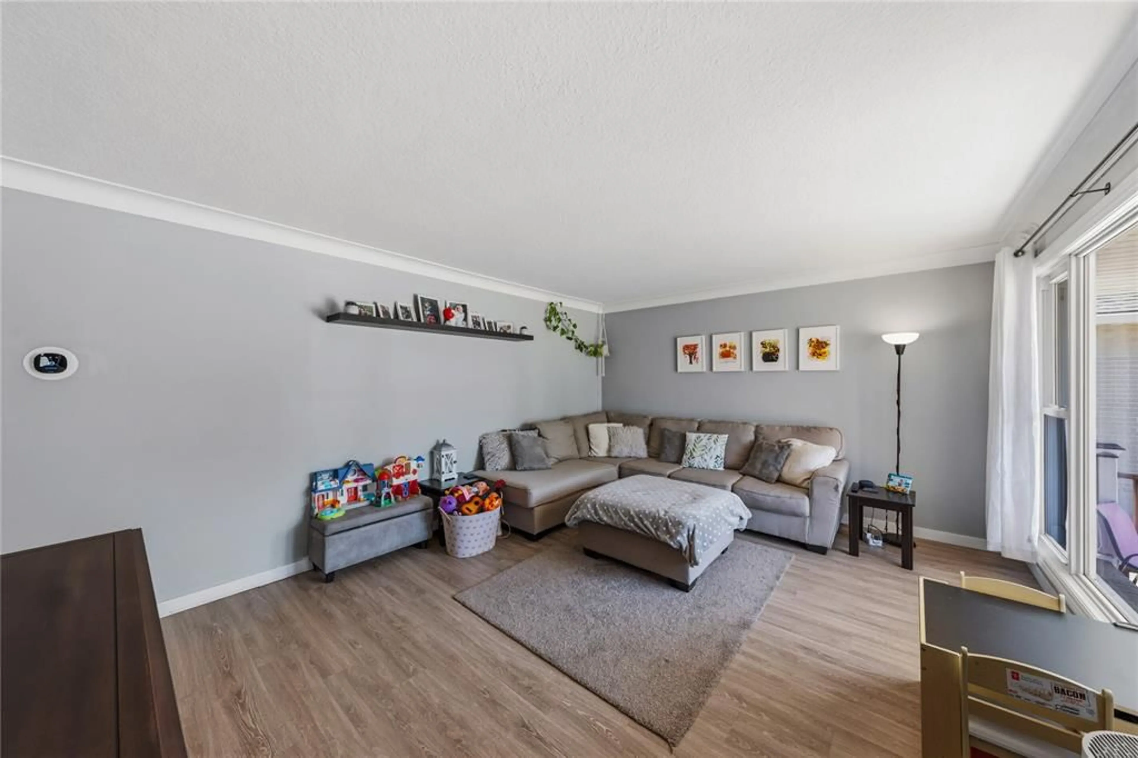 Living room with furniture, wood/laminate floor for 97 Grey Cres, Sarnia Ontario N7S 2S3
