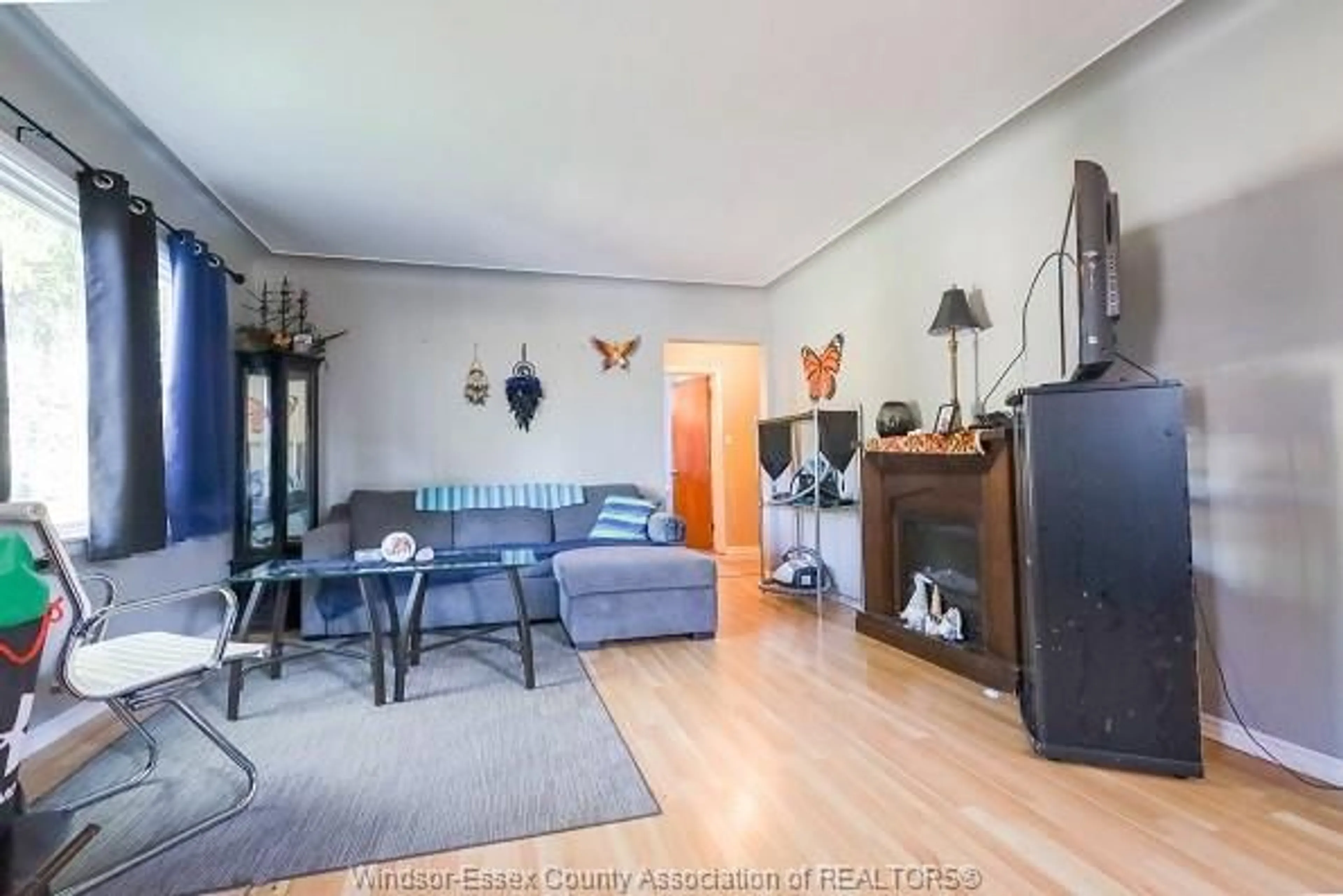 Living room with furniture, wood/laminate floor for 3124 BRUCE Ave, Windsor Ontario N9E 1W5