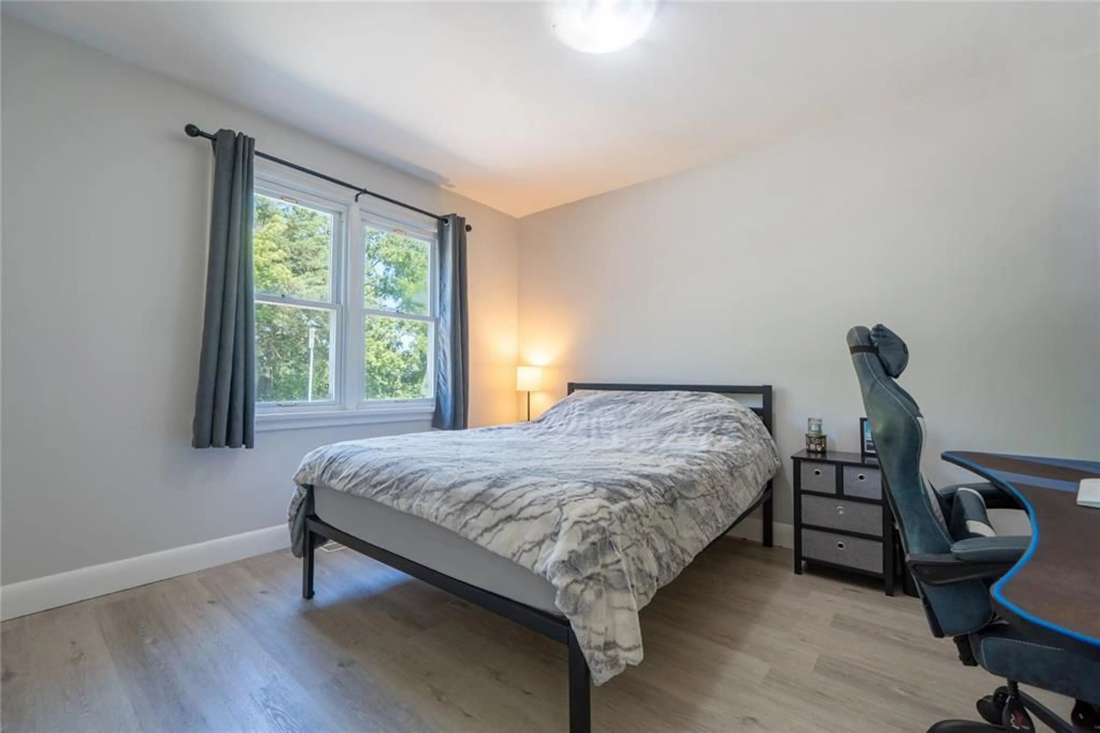 Bedroom with bed, wood/laminate floor for 5 Bank St, Tupperville Ontario N0P 2H0