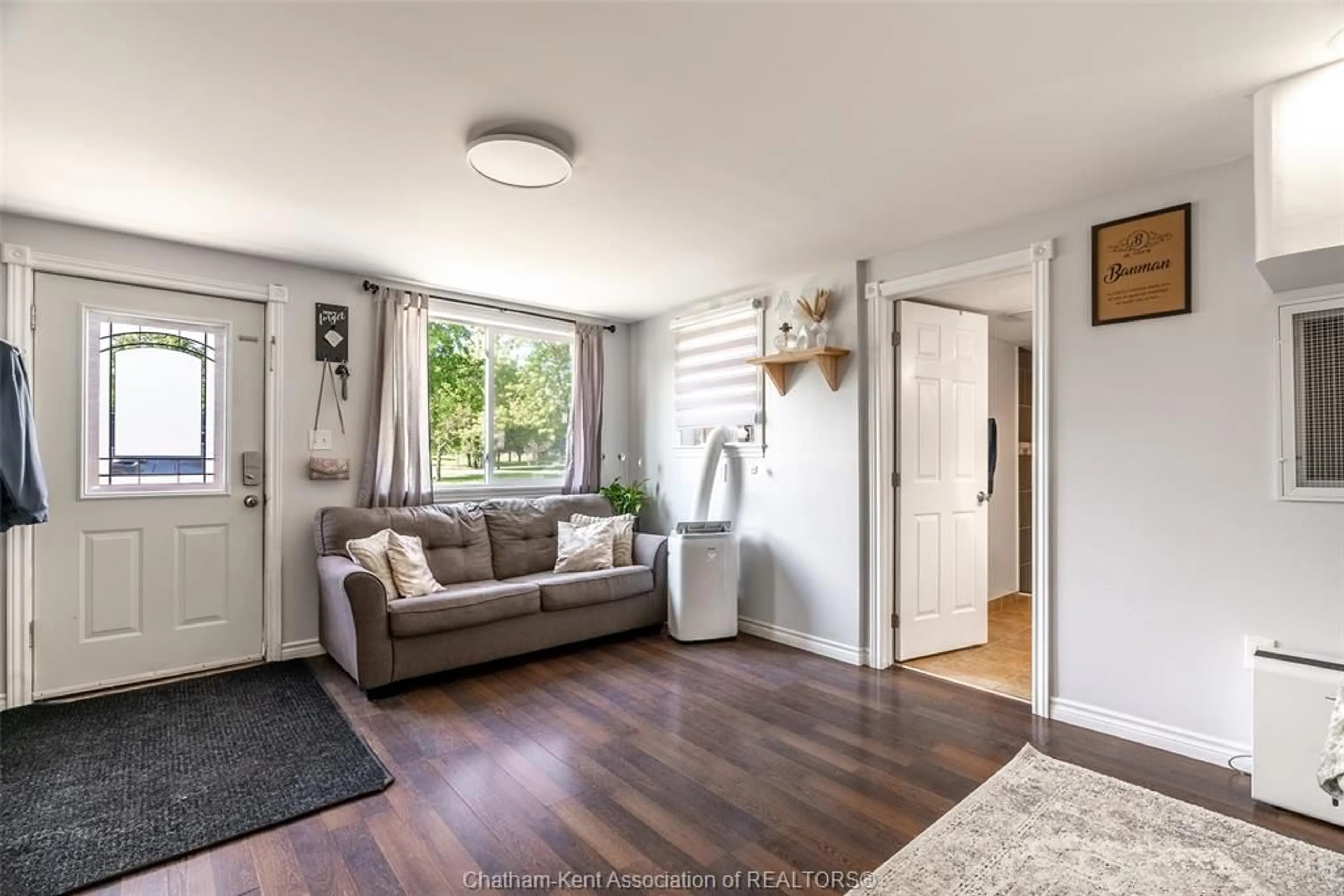 Living room with furniture, wood/laminate floor for 12502 GOLF COURSE Line, Ridgetown Ontario N0P 2C0