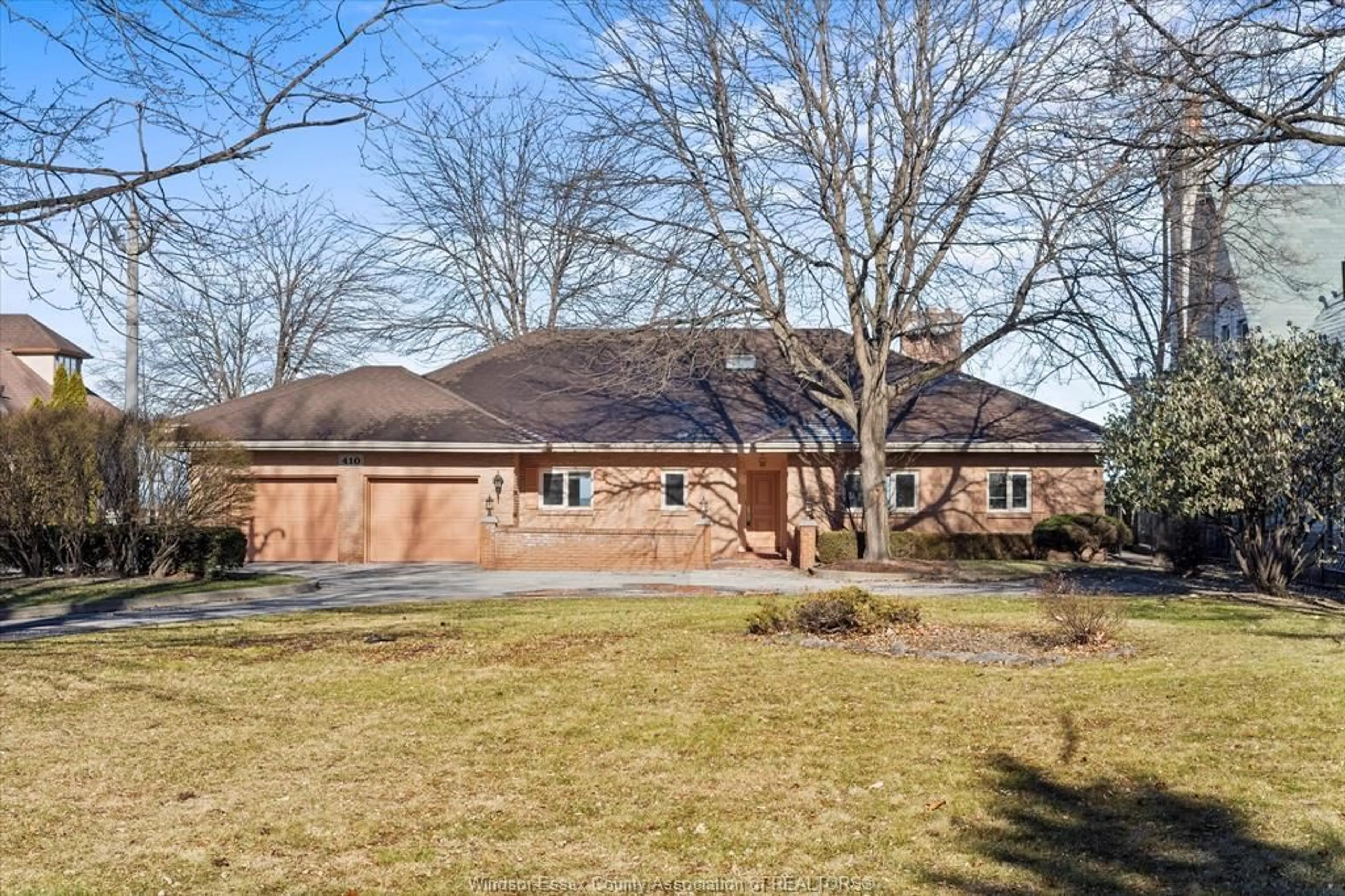 Home with brick exterior material, street for 410 RUSSELL WOODS Rd, Lakeshore Ontario N8N 3S5