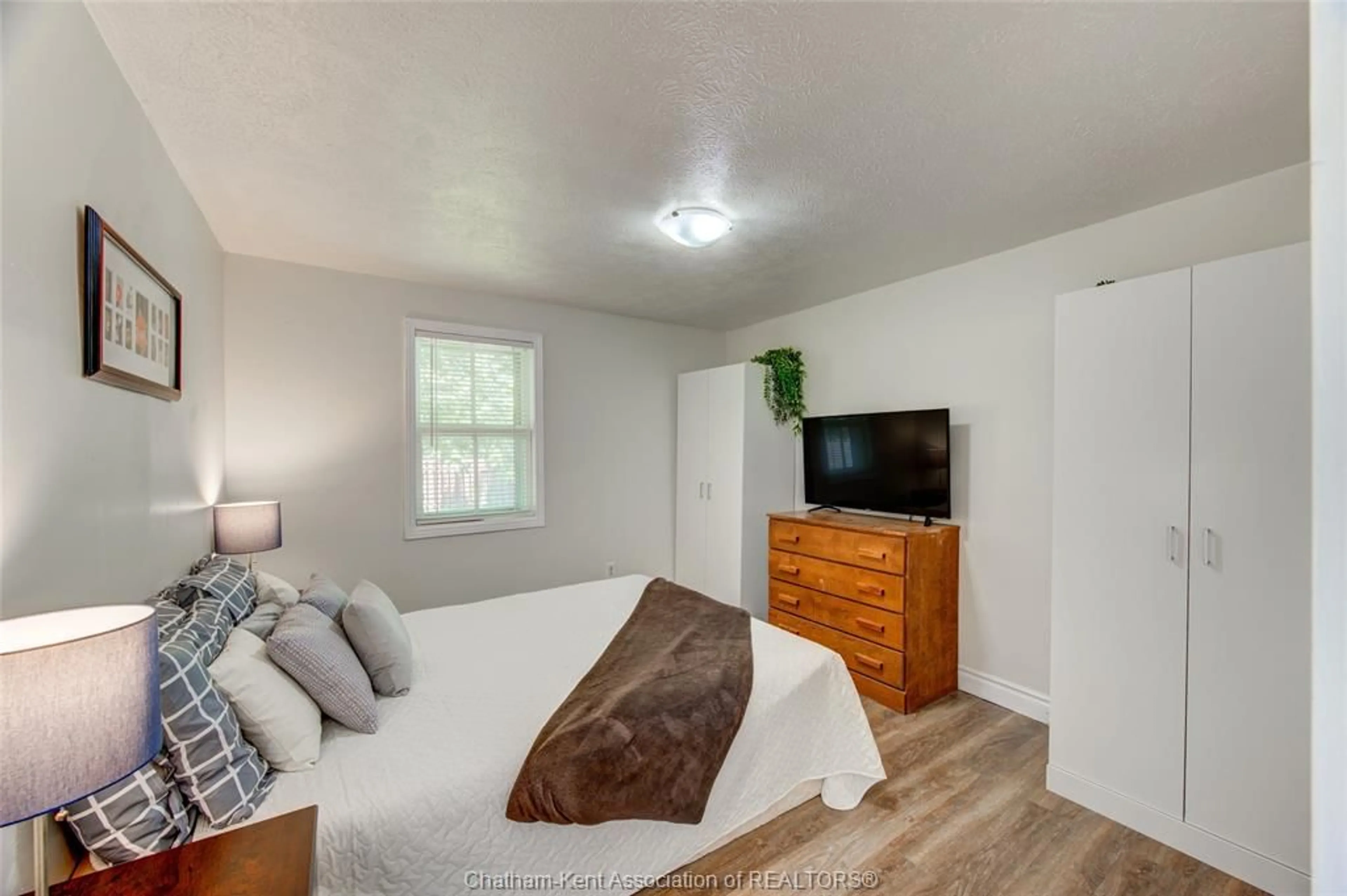Bedroom with bed, wood/laminate floor for 461 Selkirk St, Wallaceburg Ontario N8A 3X9