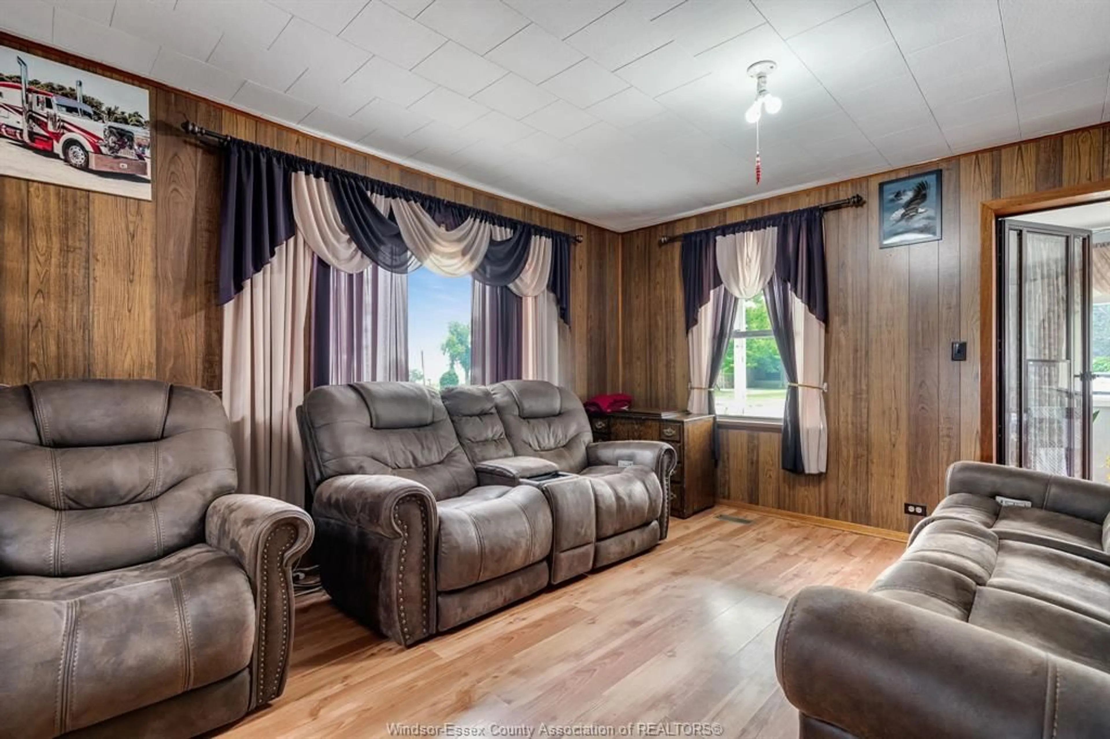 Living room with furniture, wood/laminate floor for 3070 County Rd 8, Lakeshore Ontario N0P 2J0