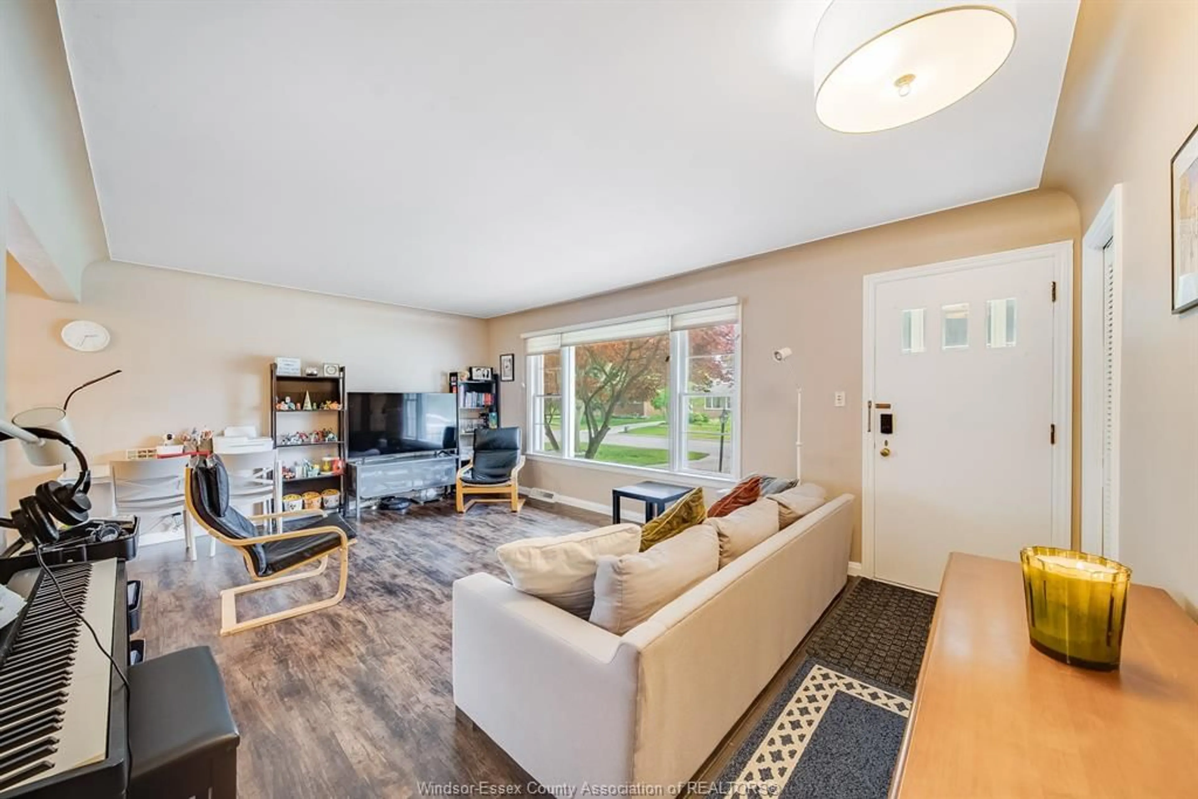 Living room with furniture, wood/laminate floor for 3063 BRUCE Ave, Windsor Ontario N9E 1W3