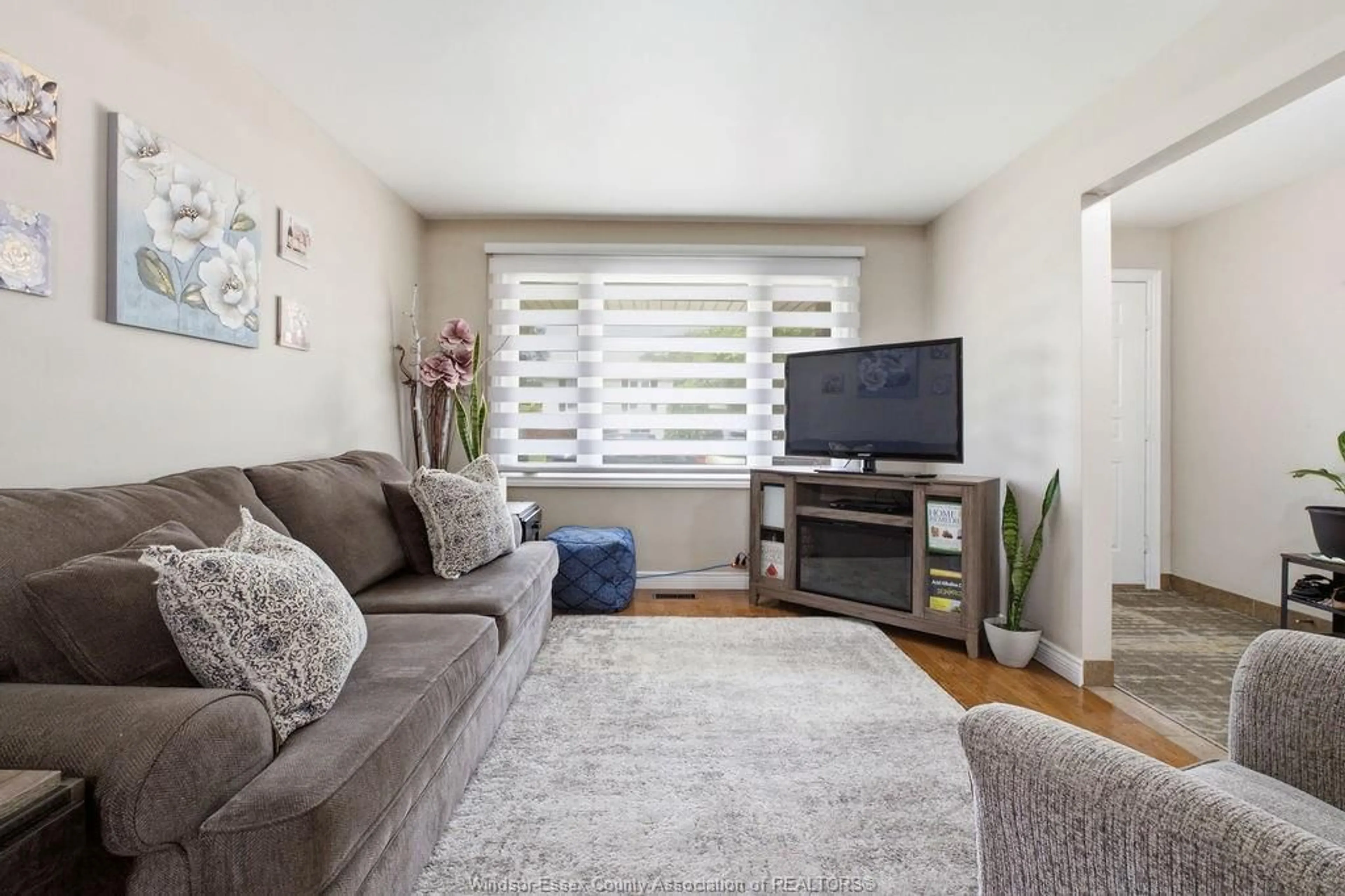 Living room with furniture, wood/laminate floor for 3375 DOLPHIN Crt, Windsor Ontario N8R 2G7