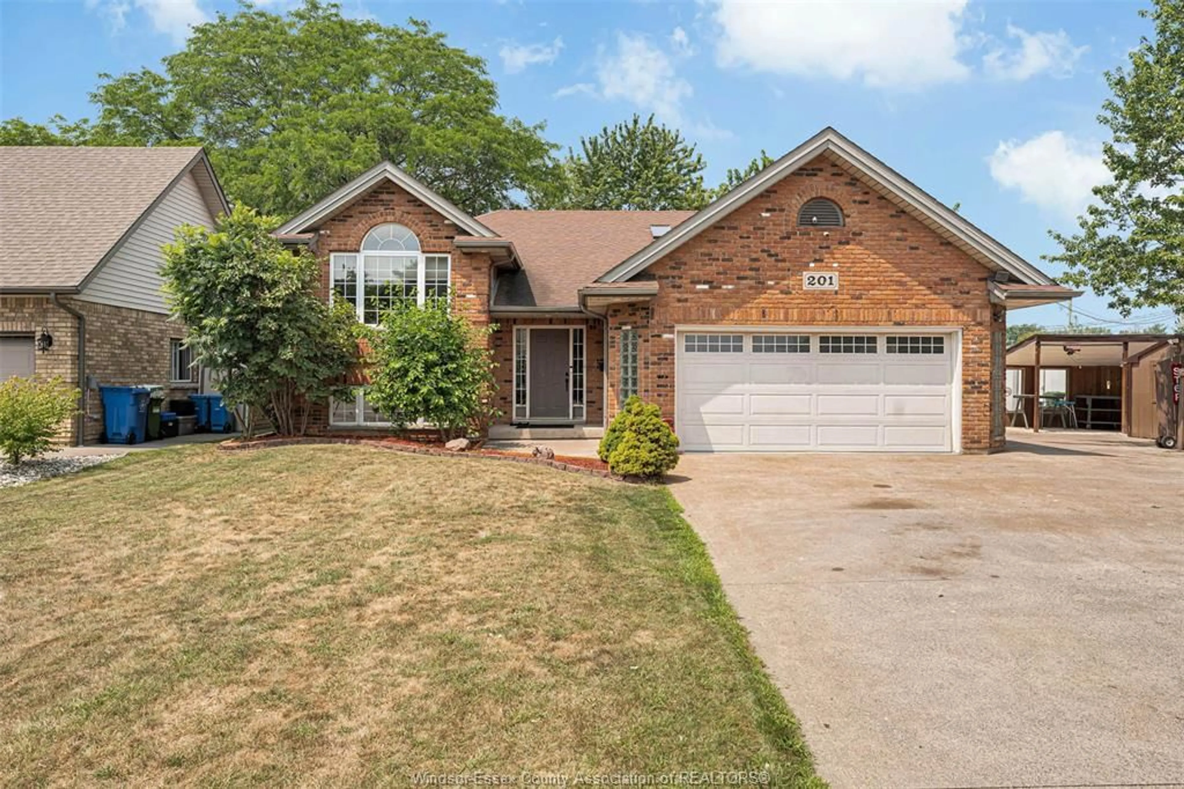 Home with brick exterior material, street for 201 MAPLEWOOD Dr, Lakeshore Ontario N8L 1C2