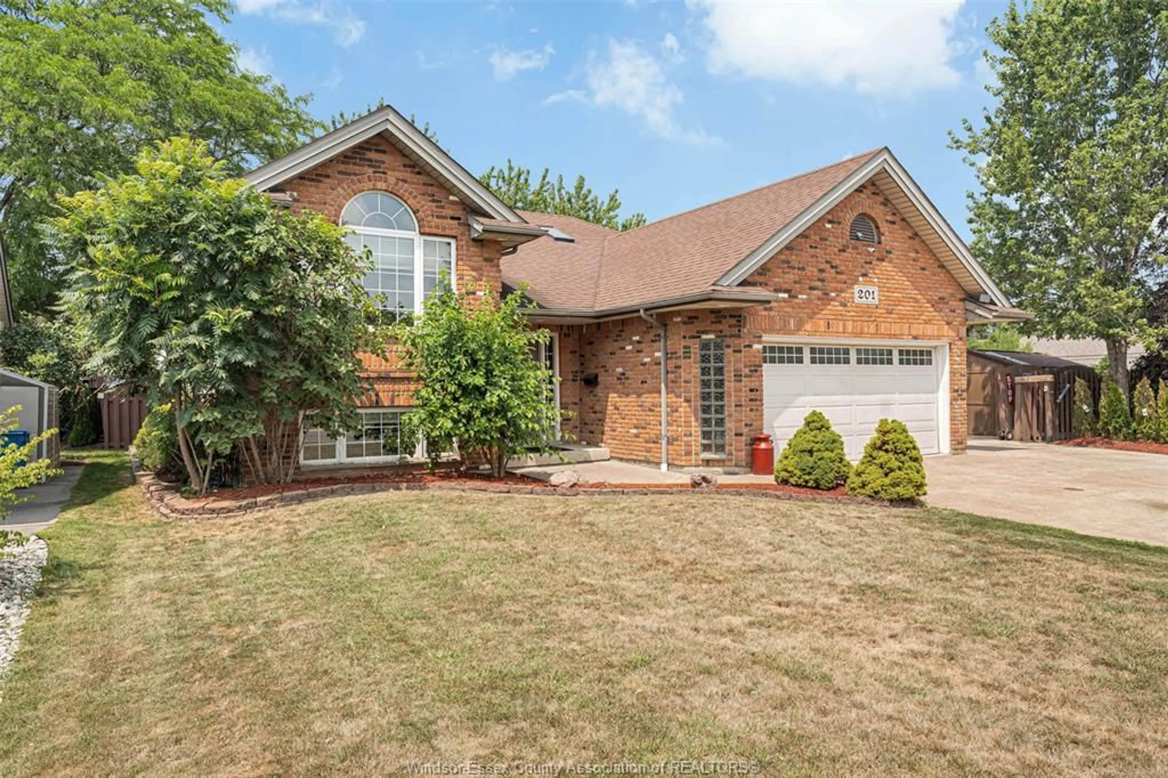 Home with brick exterior material, street for 201 MAPLEWOOD Dr, Lakeshore Ontario N8L 1C2