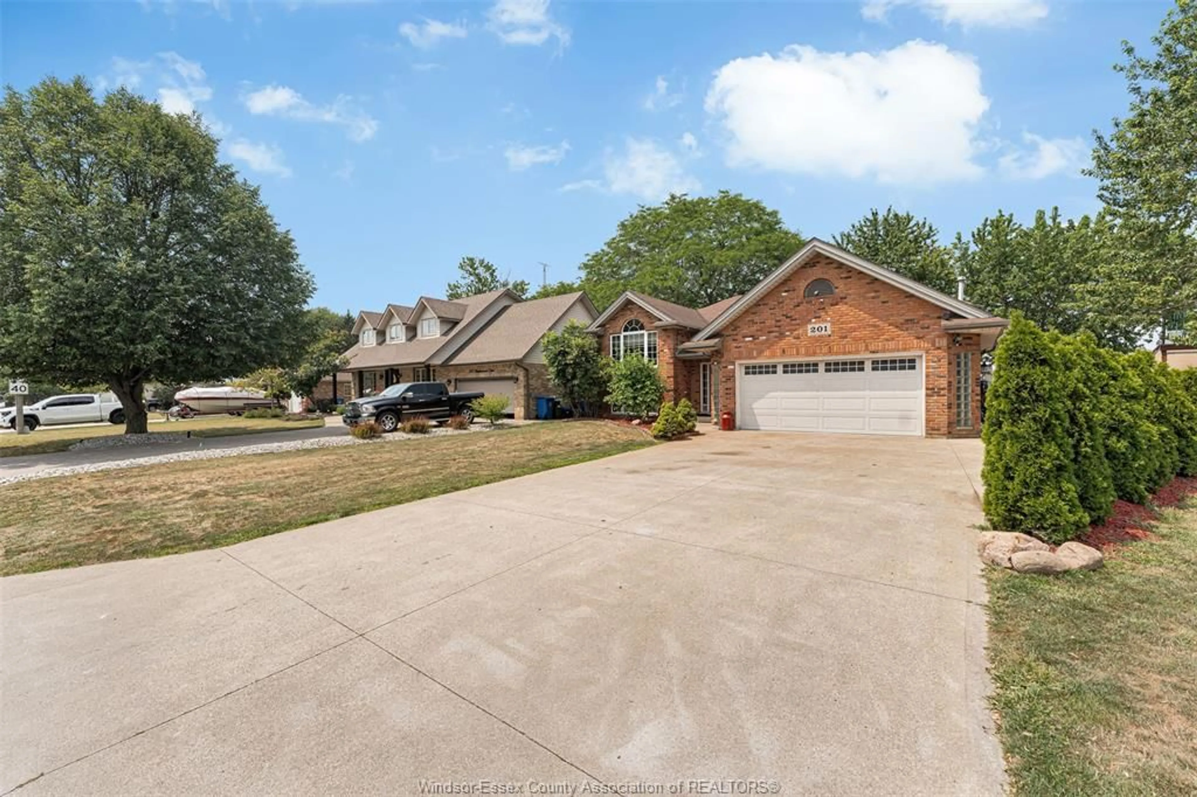Home with brick exterior material, street for 201 MAPLEWOOD Dr, Lakeshore Ontario N8L 1C2