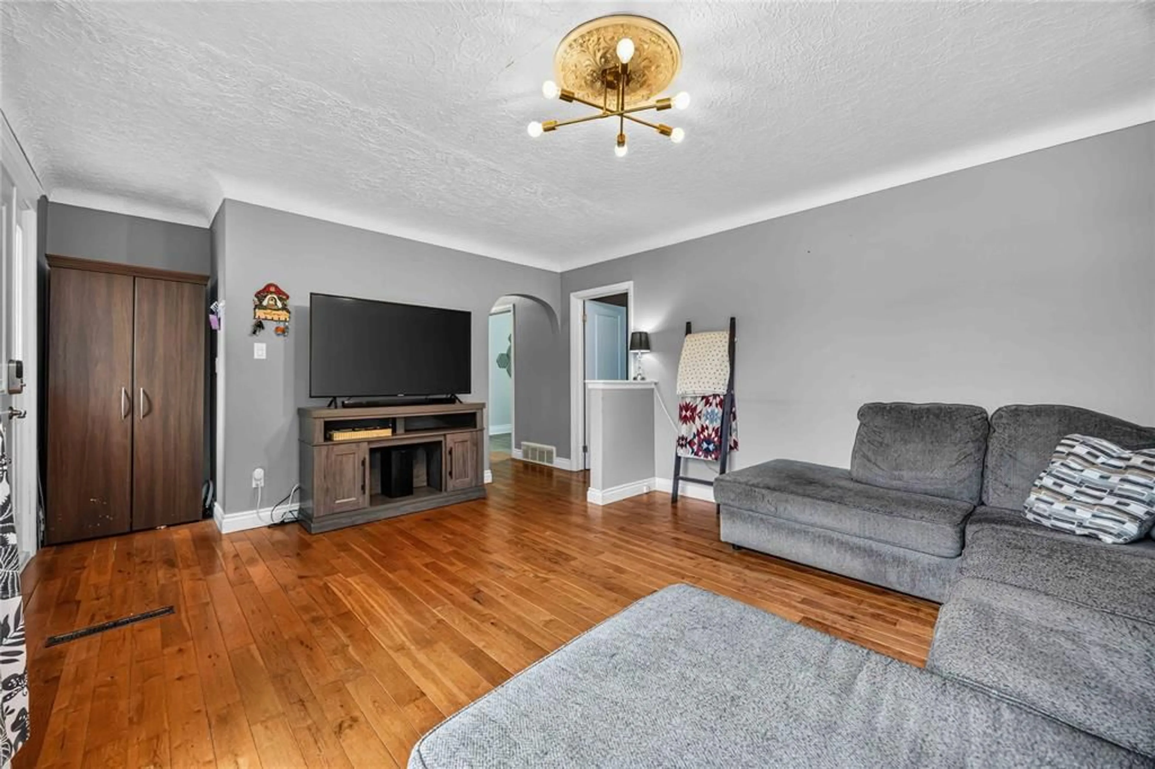 Living room with furniture, wood/laminate floor for 1108 ERROL Rd, Sarnia Ontario N7S 2E9