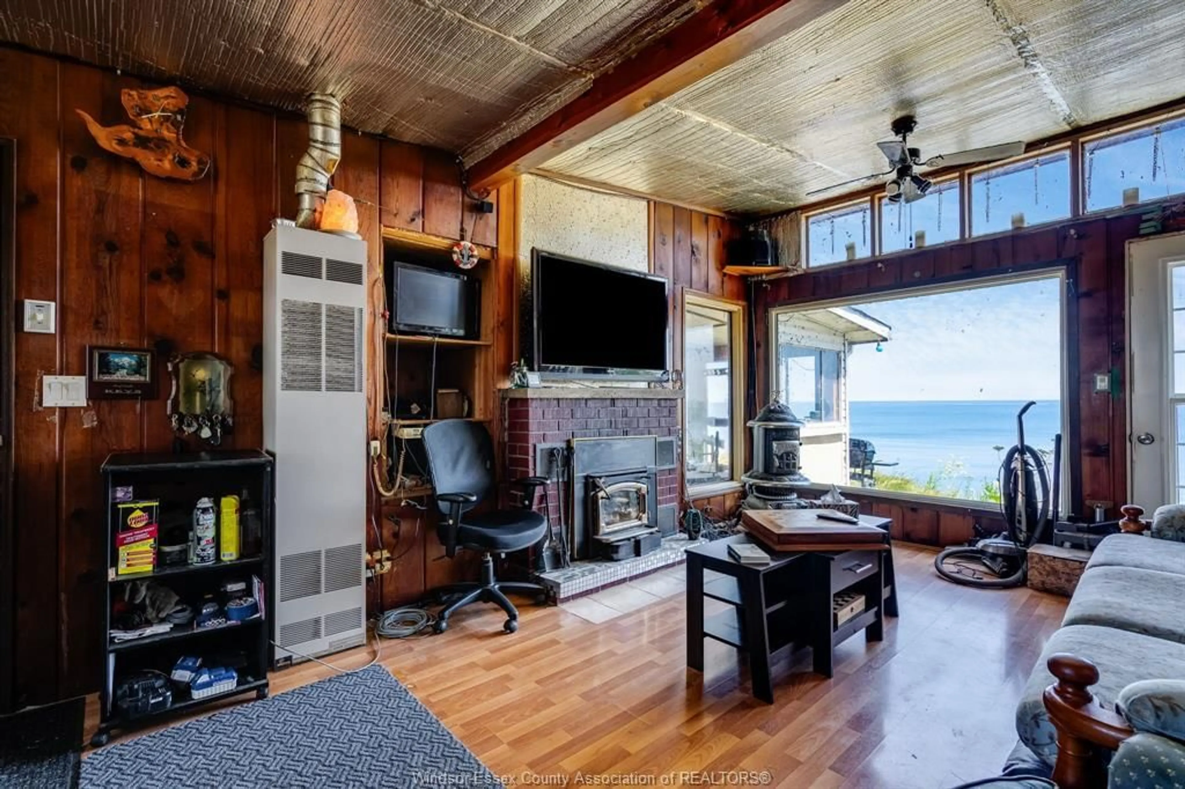 Living room with furniture, wood/laminate floor for 1624 Tilton Line, Wheatley Ontario N0P 2P0