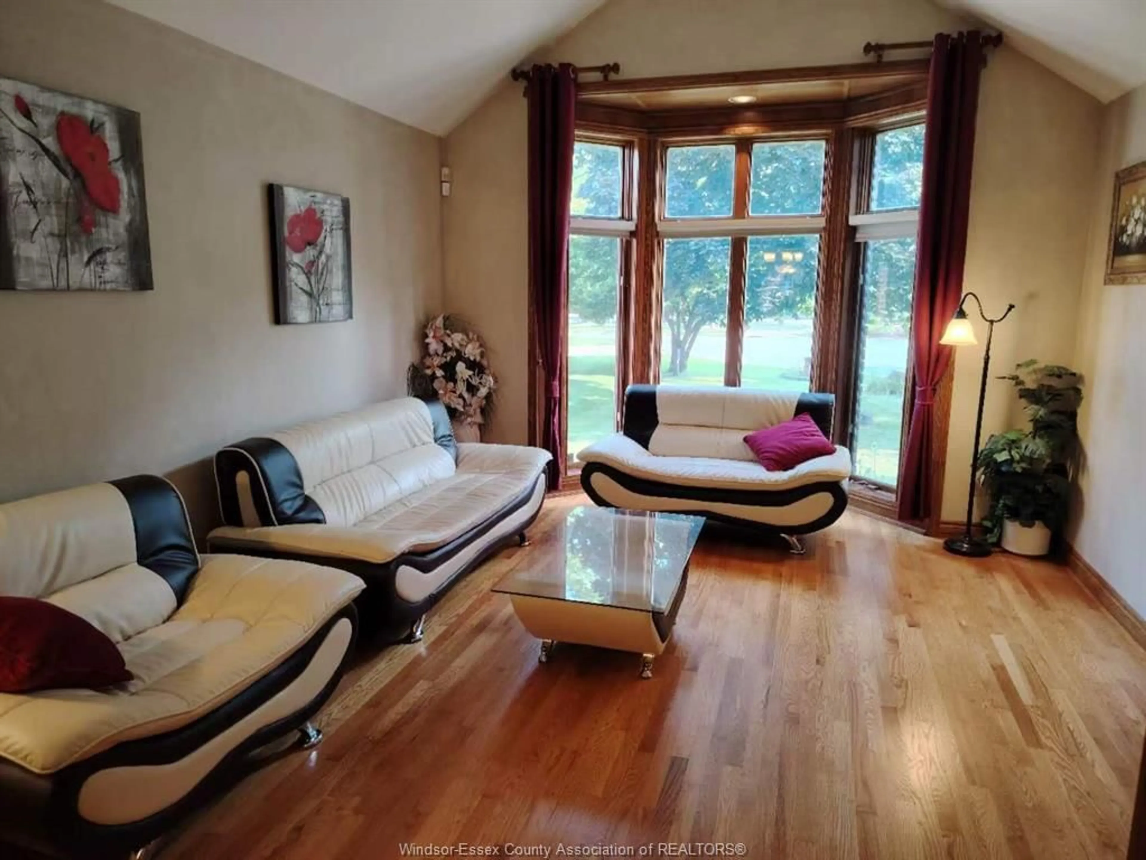 Living room with furniture, wood/laminate floor for 1985 OMIRA St, LaSalle Ontario N9H 1R4