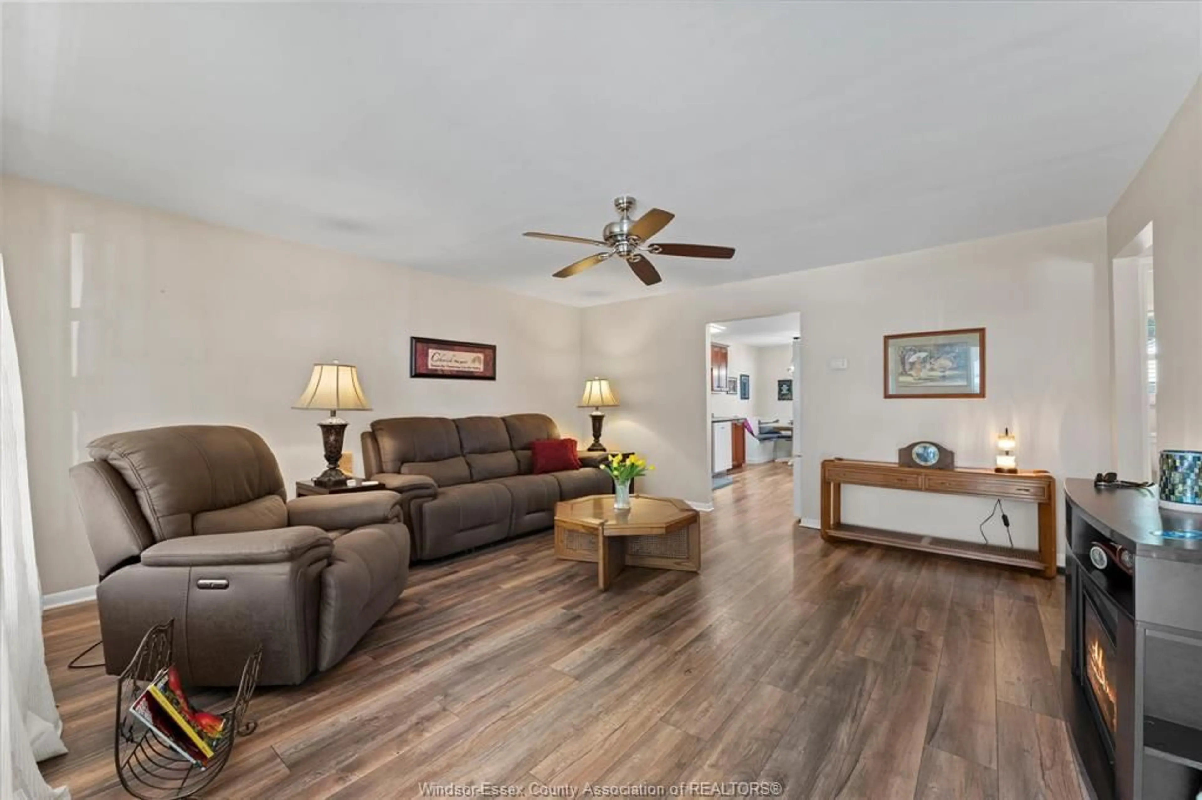 Living room with furniture, wood/laminate floor for 3560 BARRYMORE Lane, Windsor Ontario N9C 1V3