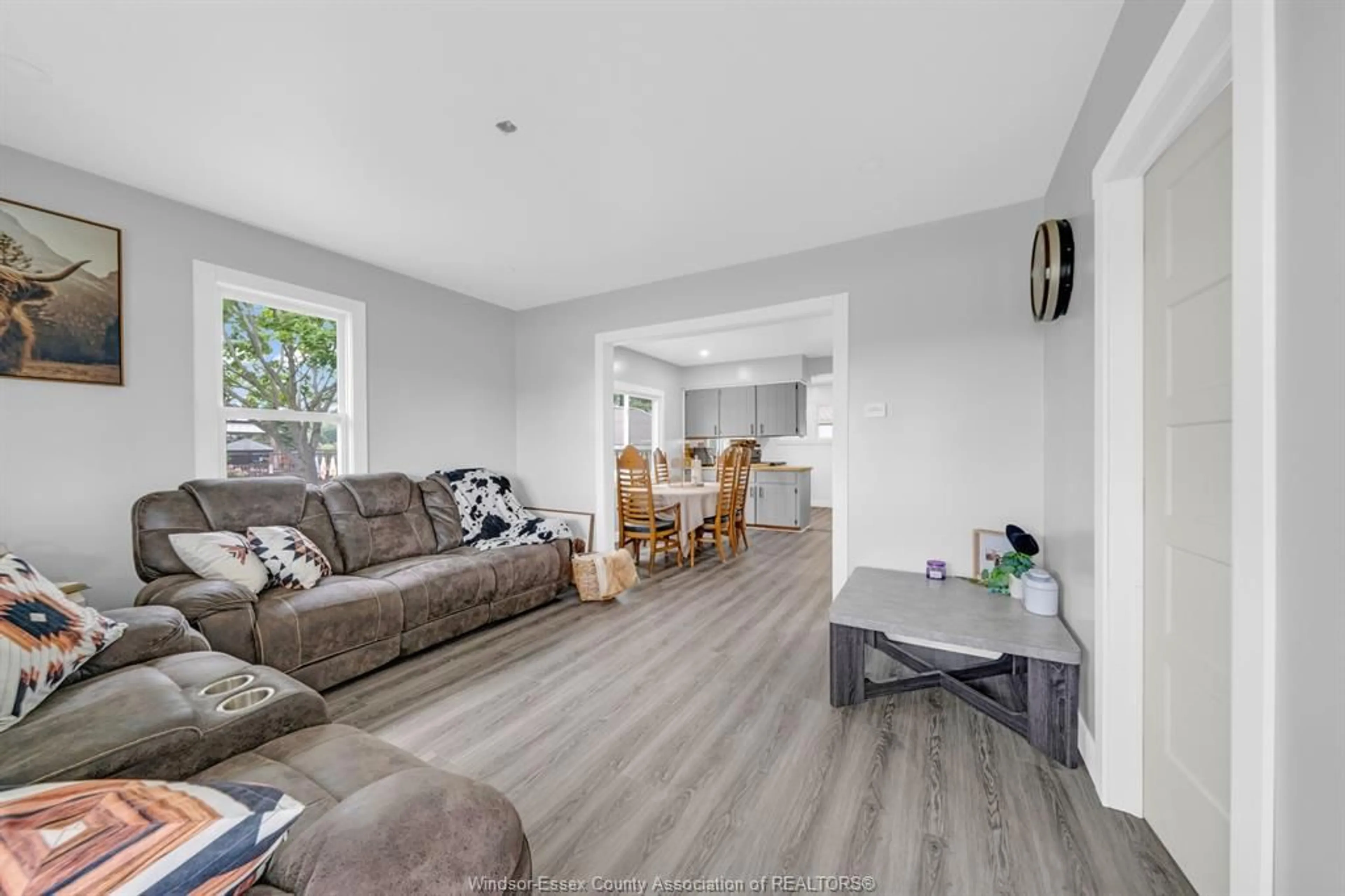 Living room with furniture, wood/laminate floor for 389 County Road 20, Kingsville Ontario N9Y 2K3