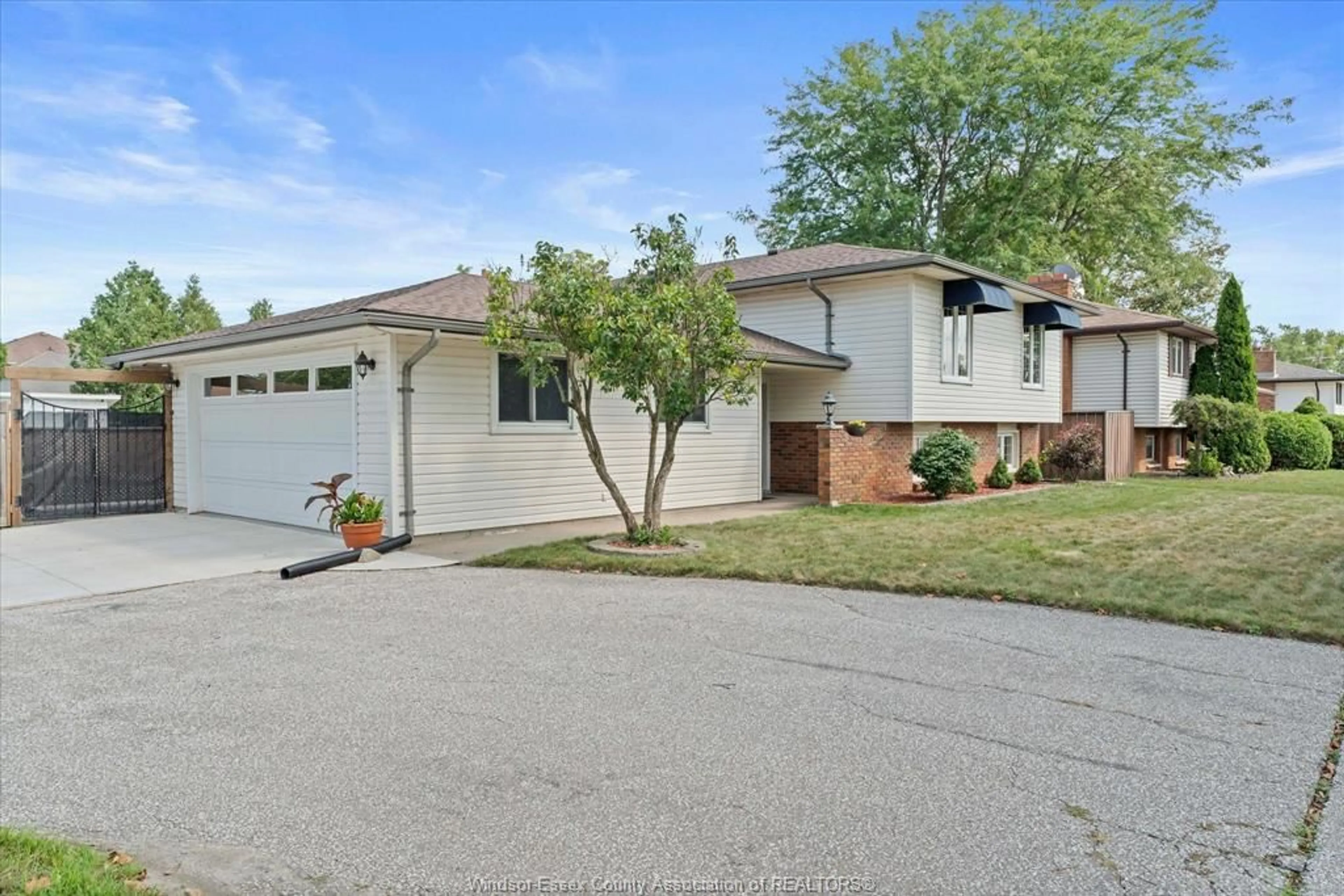 Home with vinyl exterior material, street for 2402 St. Alphonse Ave, Tecumseh Ontario N8N 2W9